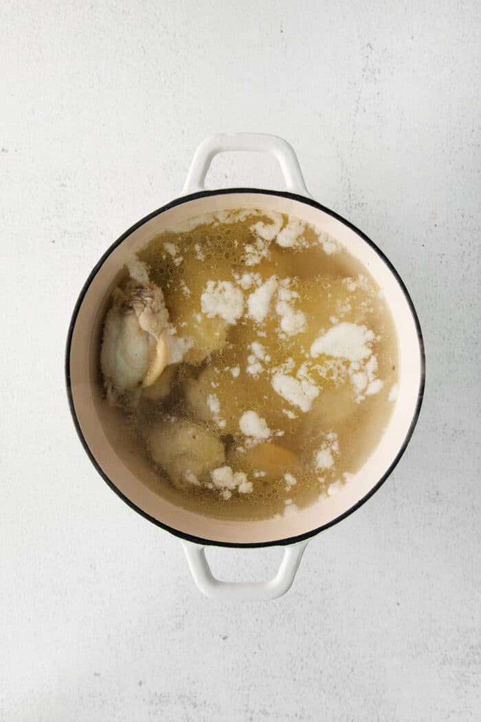 Chicken wings parboiling in a pot