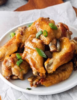 Angled view of a plate of hot honey chicken wings