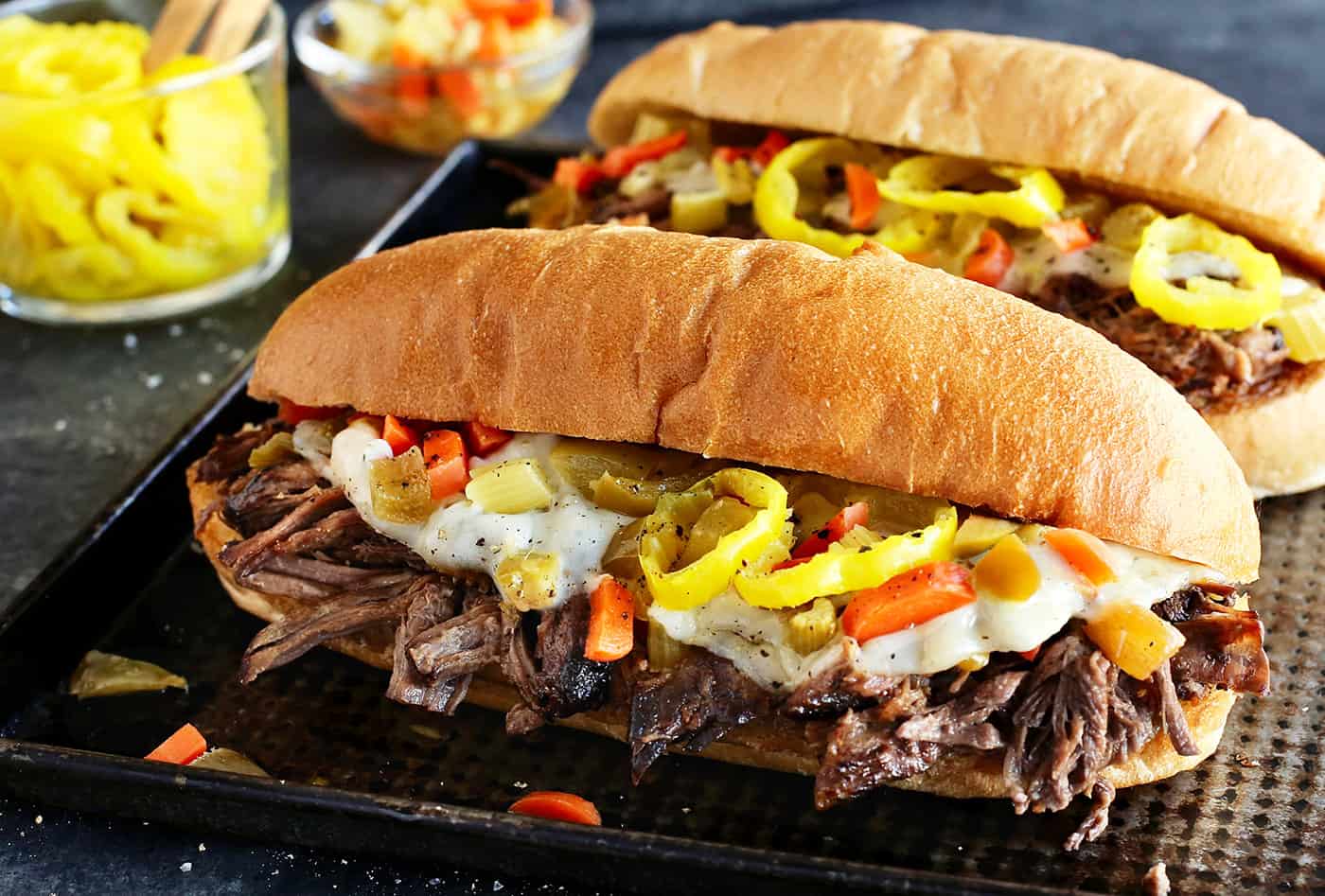 Angled view of two slow cooker Italian beef sandwiches