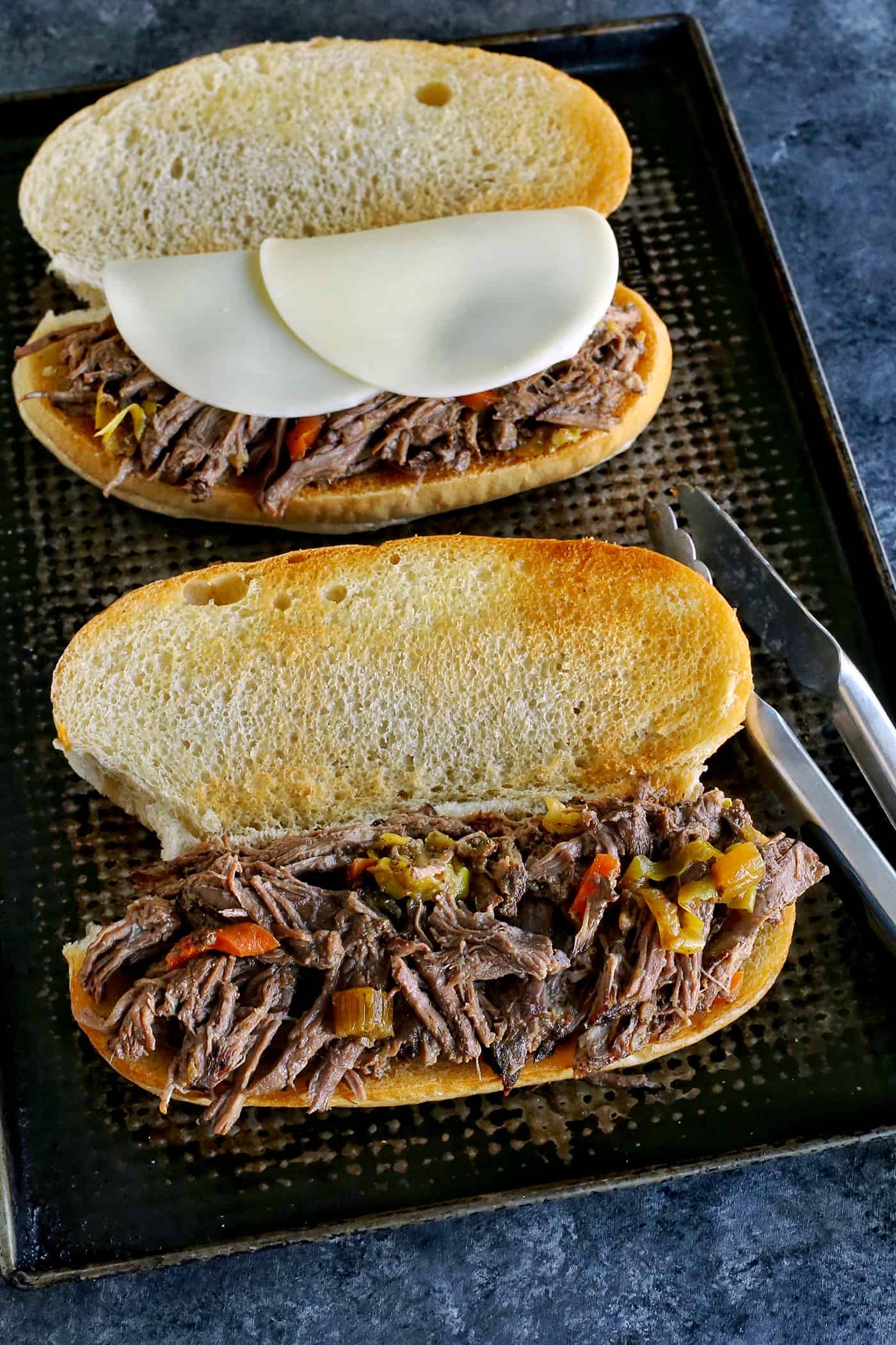 Slow cooker Italian beef on an open toasted hoagie roll