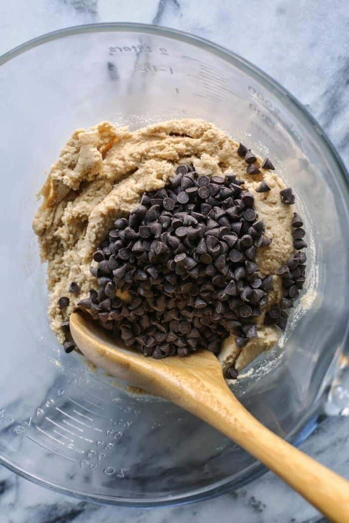 An easy edible cookie dough recipe that's egg-free and made with heat-treated flour so it's safe to eat. Refrigerate or freeze it for later! adding chocolate chips to the cookie dough