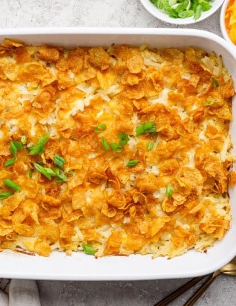 Overhead view of cheesy hashbrown casserole in baking dish