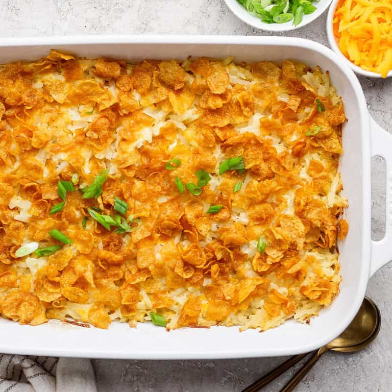 Overhead view of cheesy hashbrown casserole in baking dish