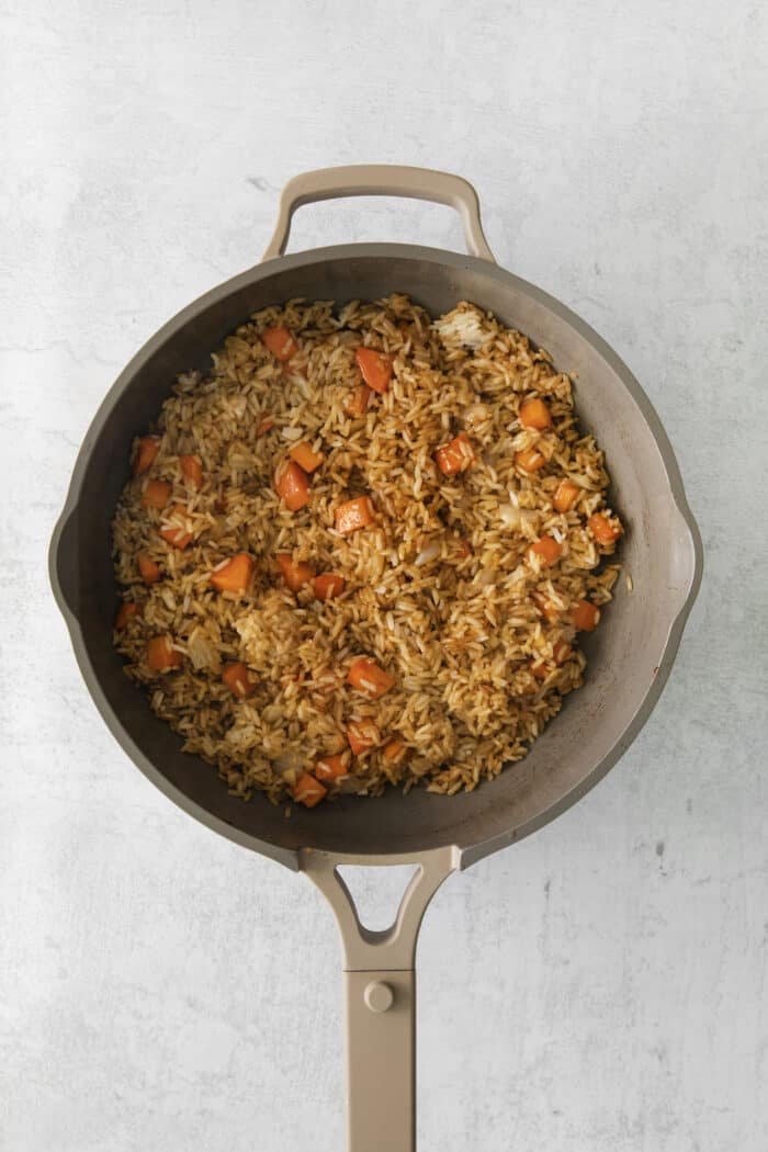 Fried rice with carrots in a skillet