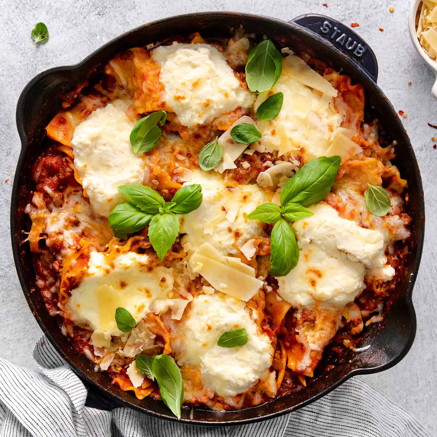 This skillet lasagna recipe has all the classic lasagna ingredients, without the extra dishes and layering! Perfect for weeknight dinners. Overhead view of skillet lasagna