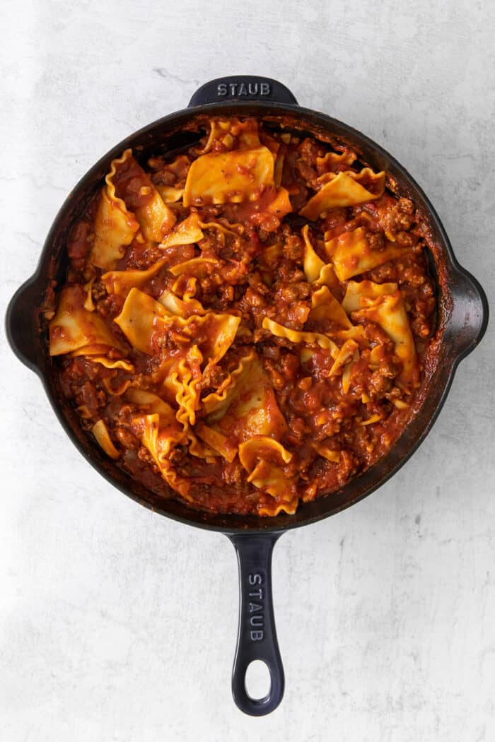 This skillet lasagna recipe has all the classic lasagna ingredients, without the extra dishes and layering! Perfect for weeknight dinners. Lasagna noodles and sauce mixed together in a skillet