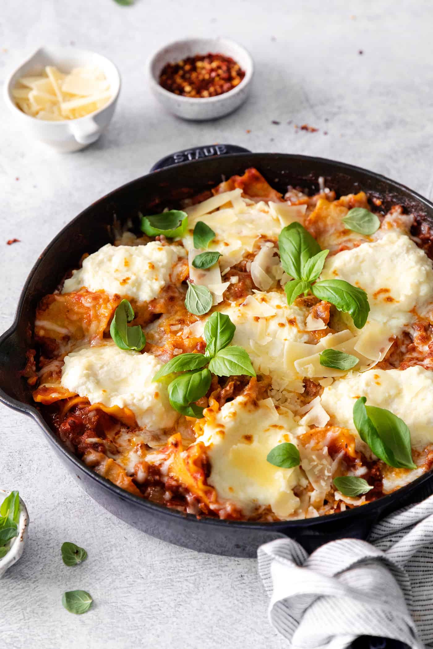 This skillet lasagna recipe has all the classic lasagna ingredients, without the extra dishes and layering! Perfect for weeknight dinners. Angled view of freshly made skillet lasagna