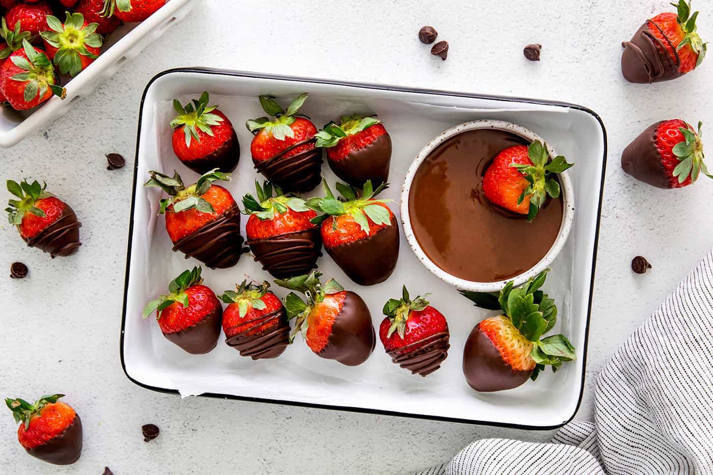 These Chocolate Covered Strawberries may look fancy and elegant, but are actually a quick and easy treat to make, with just 3 ingredients! Overhead view of chocolate covered strawberries