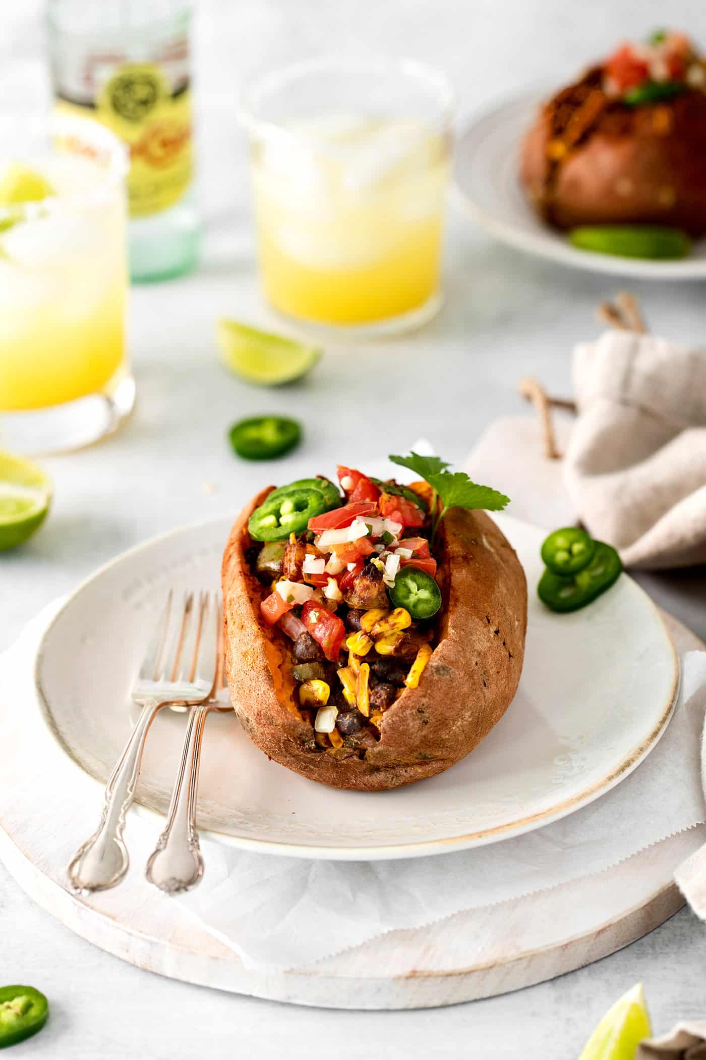 A taco stuffed sweet potato on a white plate
