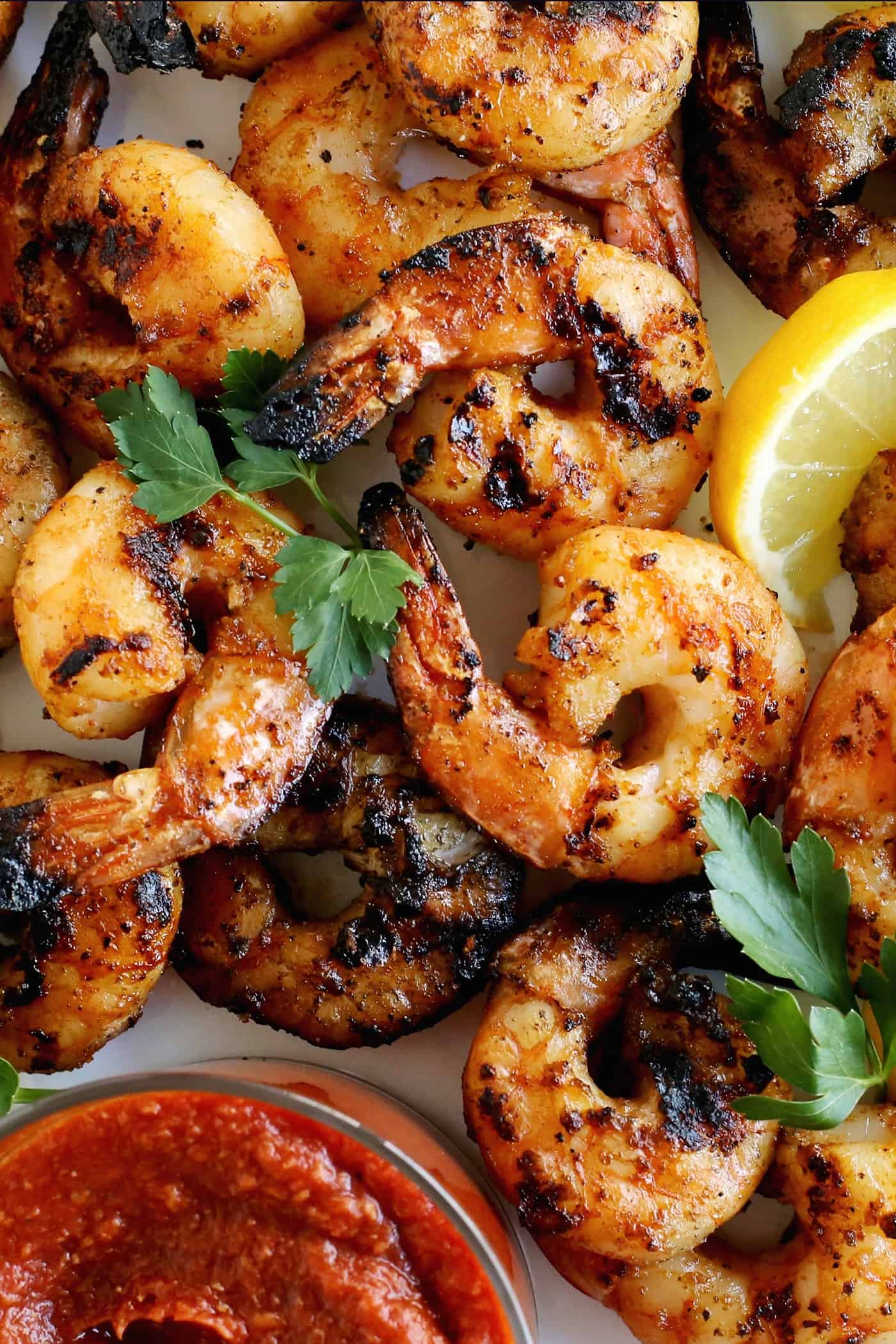 Tossed with olive oil and a few spices, this easy shrimp cocktail is perfectly flavored and grilled until just charred. So good! Close up of grilled shrimp.