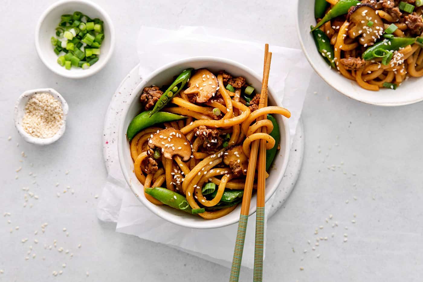 Overhead view of a bowl of yaki udon with chopsticks