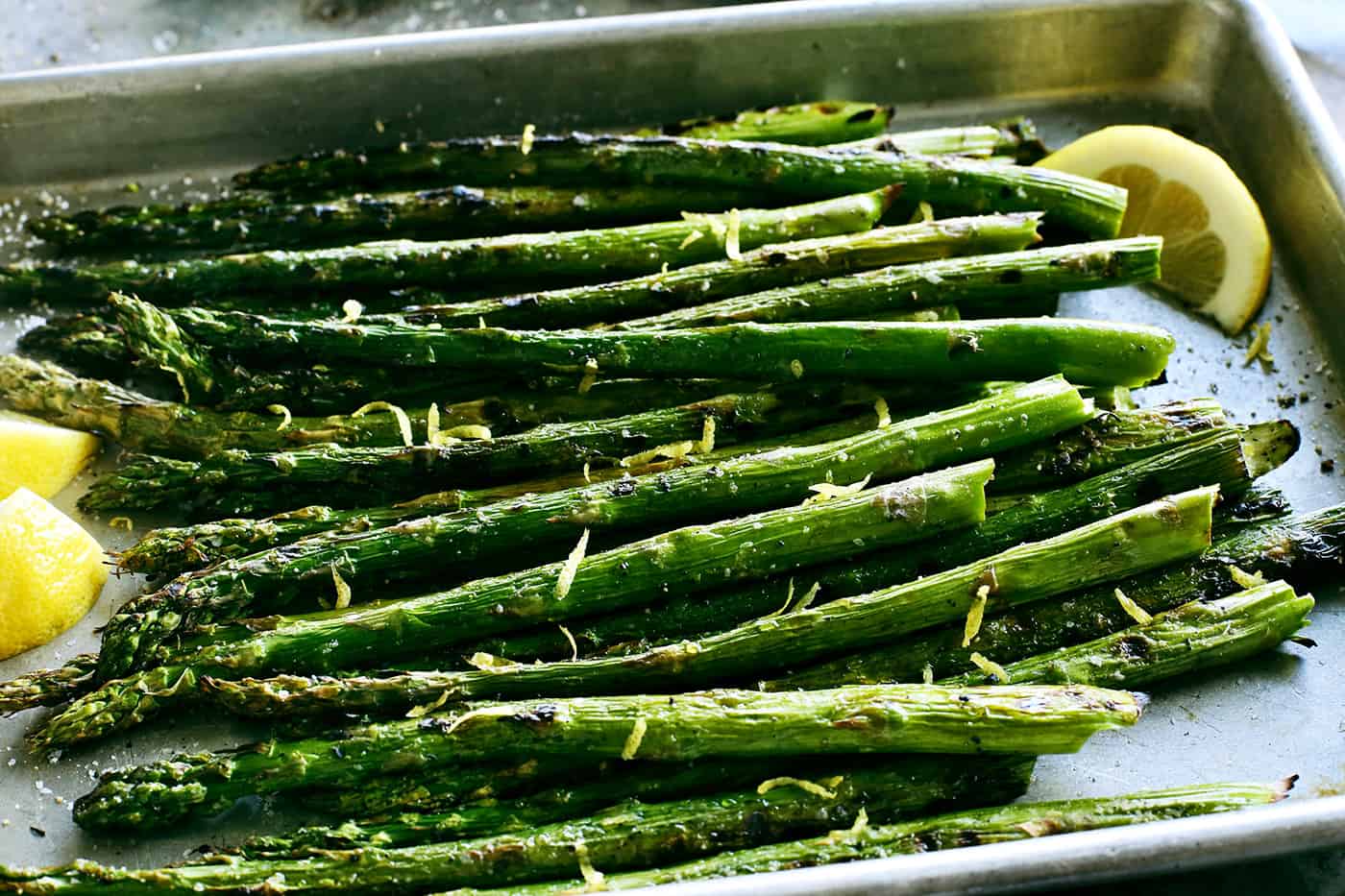 With just 2 ingredients, this Grilled Asparagus is an easy side dish that can be prepared in just 20 minutes. Overhead view of asparagus with lemon