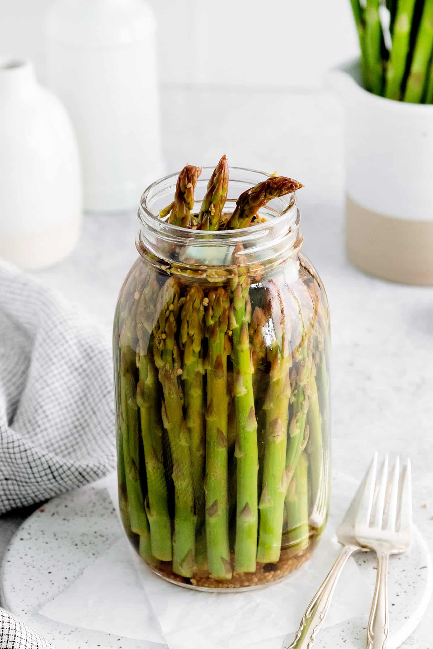 With a simple pickling brine and a few spices, these Quick Pickled Asparagus has a tangy, robust flavor with just a bit of heat. An open jar of asparagus
