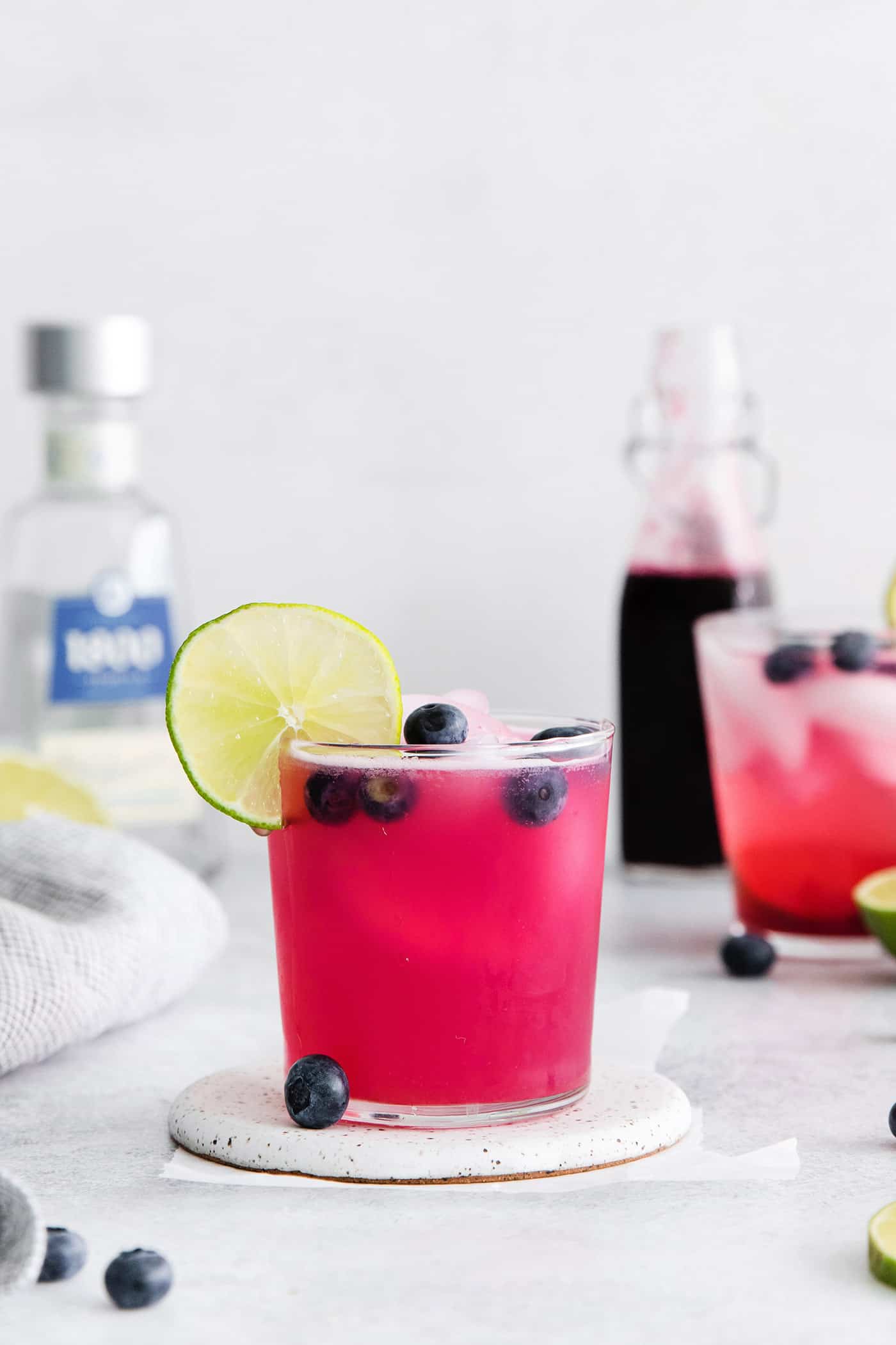 Made with flavored simple syrup, this Blueberry Margarita is just the fruity cocktail for summer. Sweet but tart and super refreshing! A blueberry margarita garnished with a lime slice