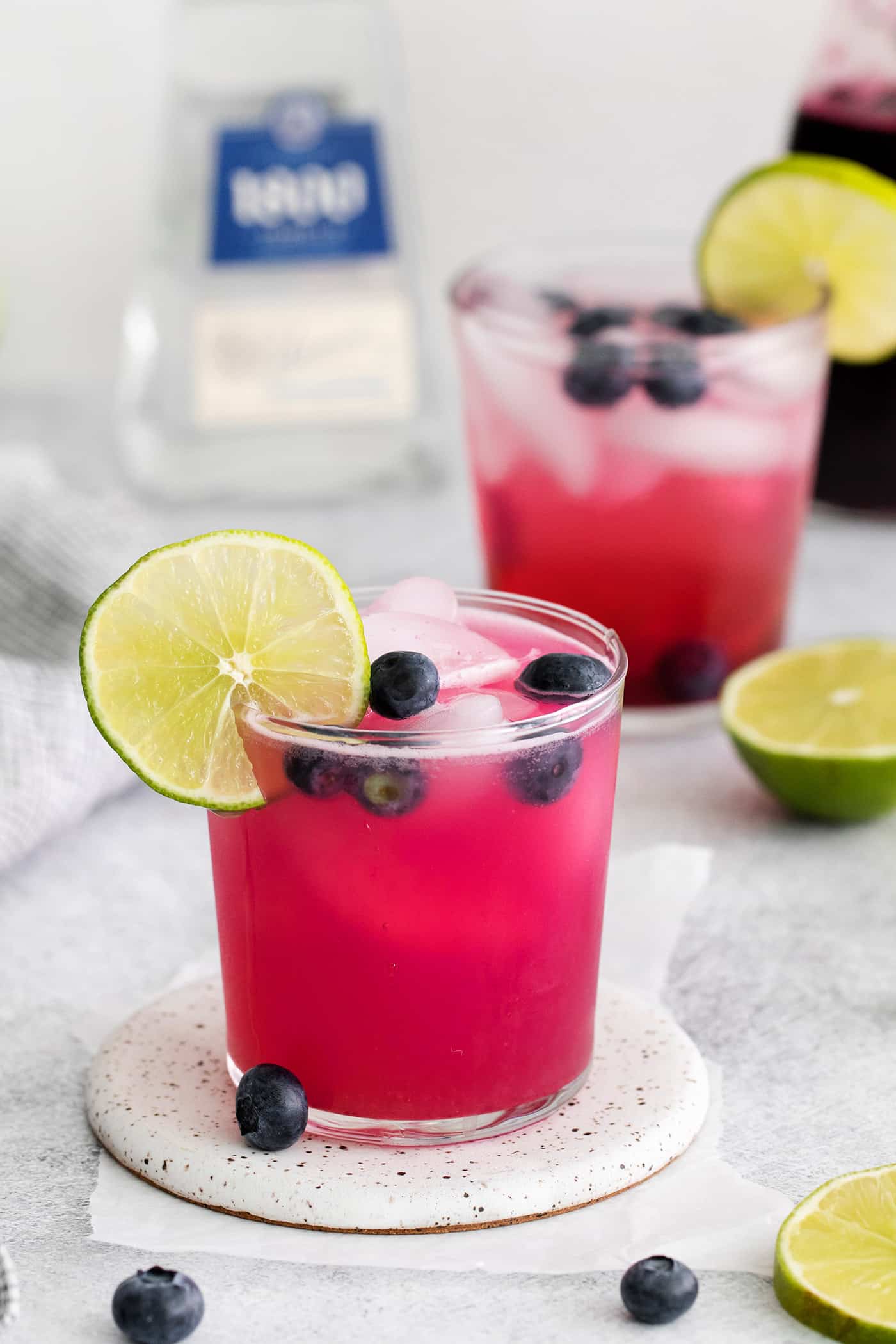 Made with flavored simple syrup, this Blueberry Margarita is just the fruity cocktail for summer. Sweet but tart and super refreshing! Angled view of a blueberry margarita with a lime slice