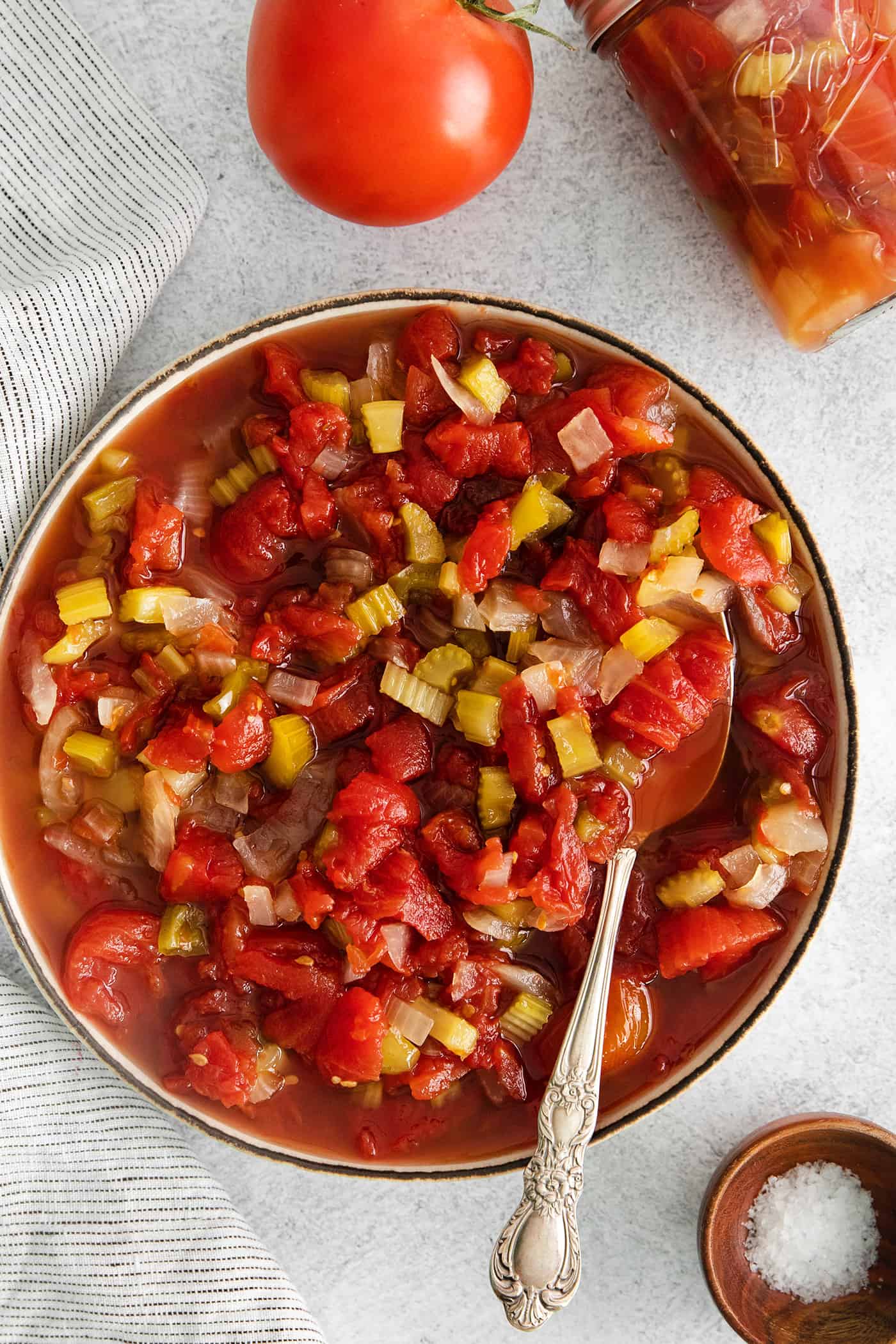 Made with juicy tomatoes, celery, onion, and green pepper these Chili Stewed Tomatoes make a mouthwatering side dish. Overhead view of a bowl of chili stewed tomatoes