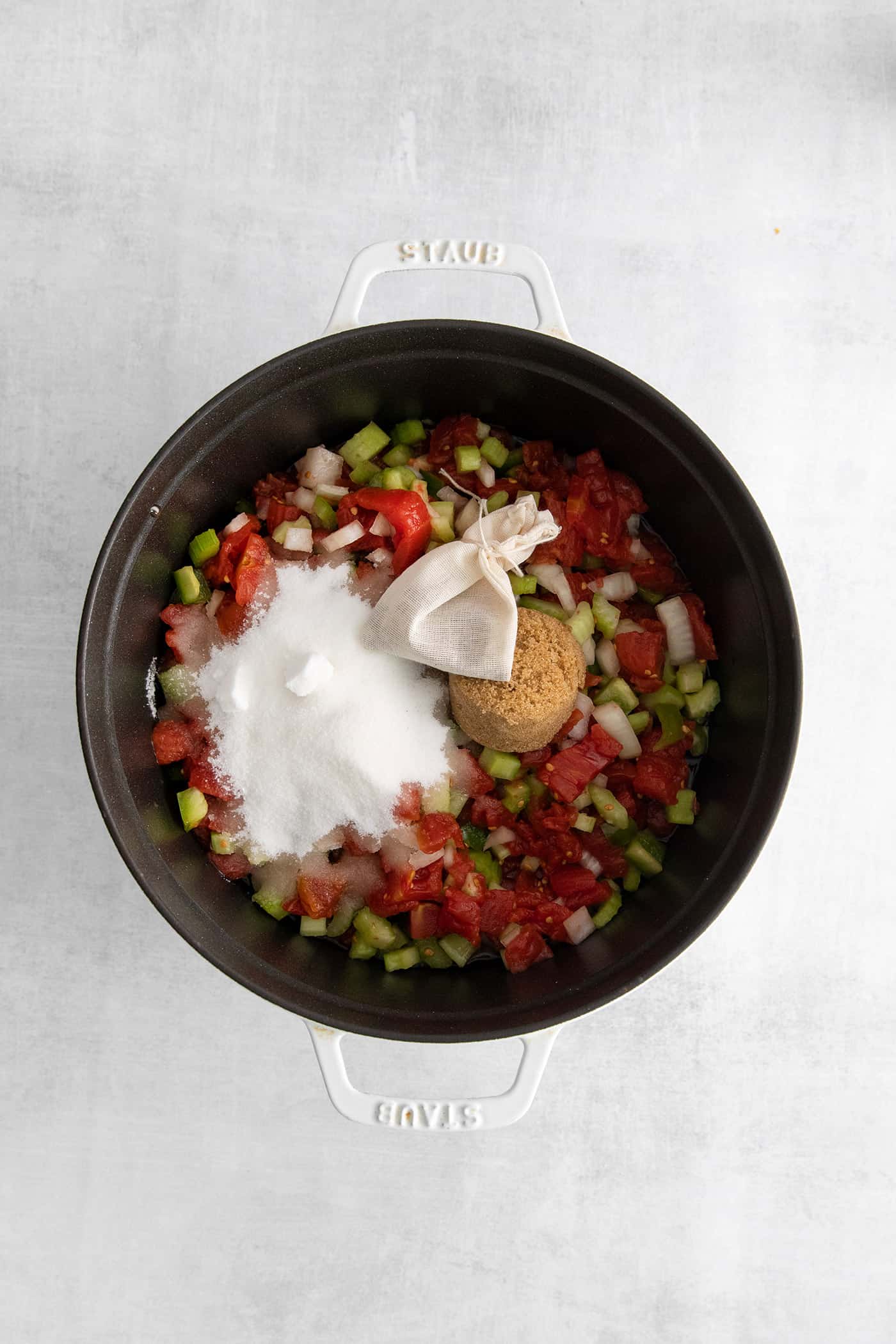 Made with juicy tomatoes, celery, onion, and green pepper these Chili Stewed Tomatoes make a mouthwatering side dish. Tomatoes, diced veggies, sugar, and pickling spices in a pot
