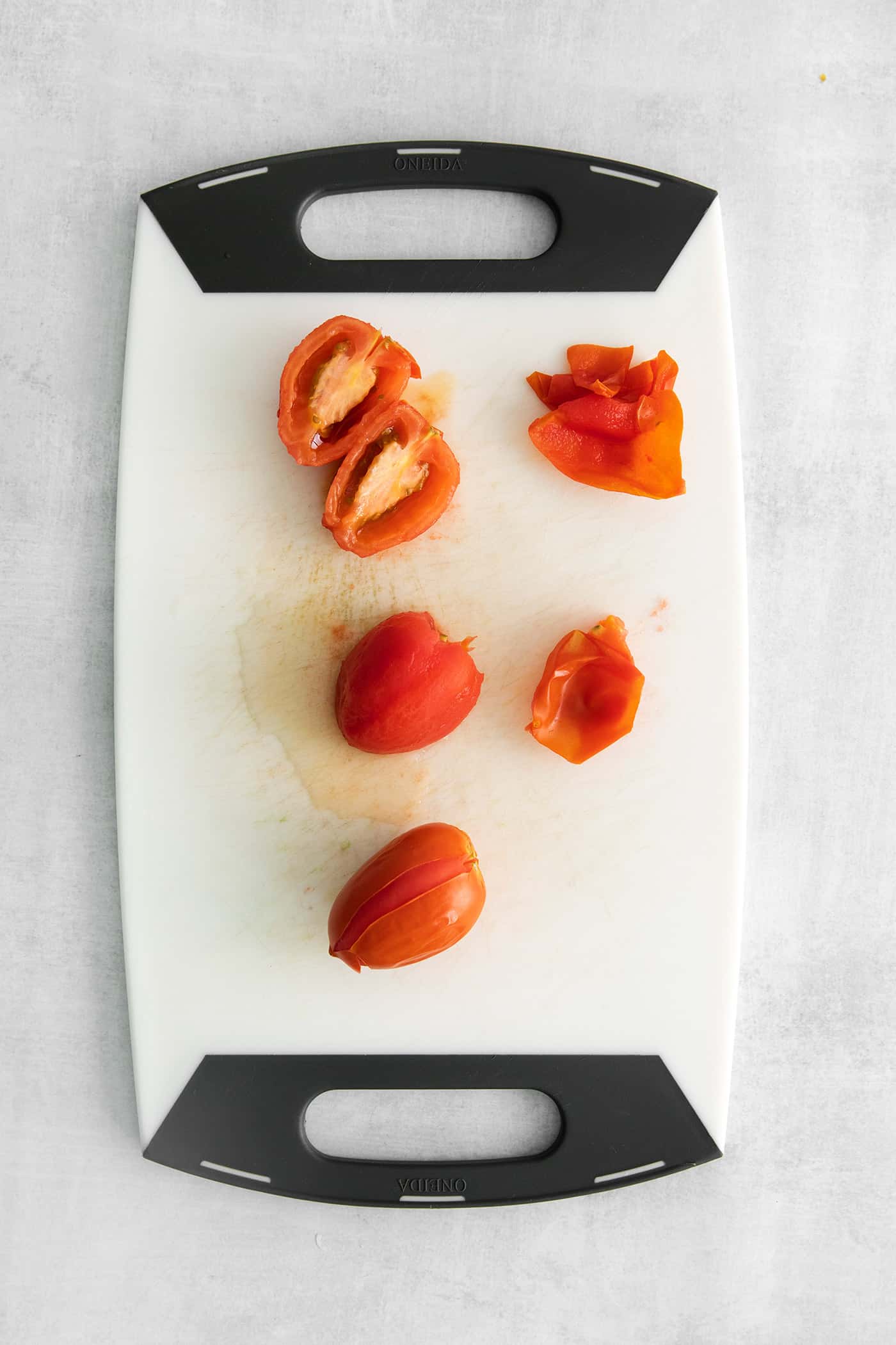 Made with juicy tomatoes, celery, onion, and green pepper these Chili Stewed Tomatoes make a mouthwatering side dish. Skinned tomatoes and tomatoes cut in half on a cutting board