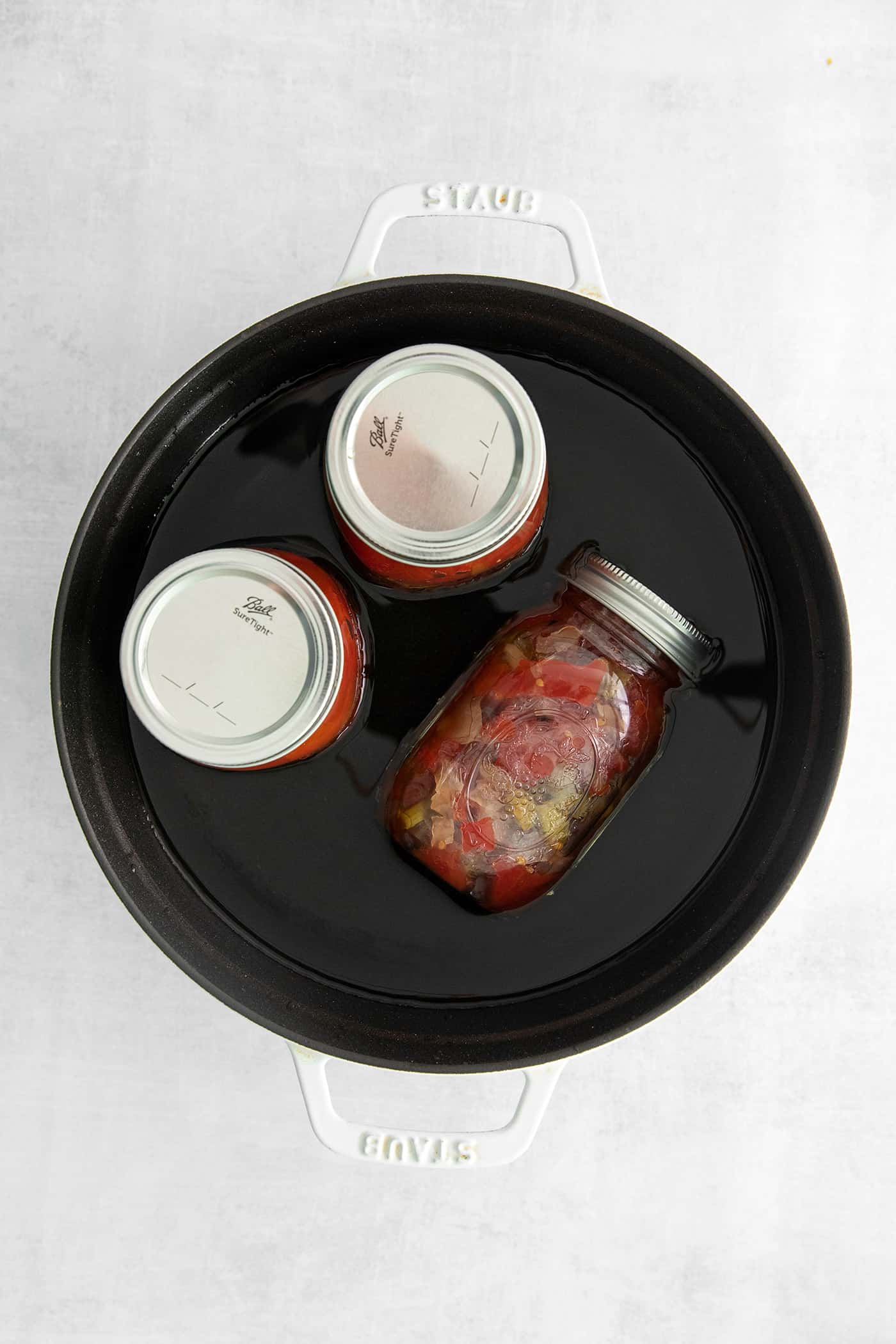 Made with juicy tomatoes, celery, onion, and green pepper these Chili Stewed Tomatoes make a mouthwatering side dish. Jars of stewed tomatoes in a water bath
