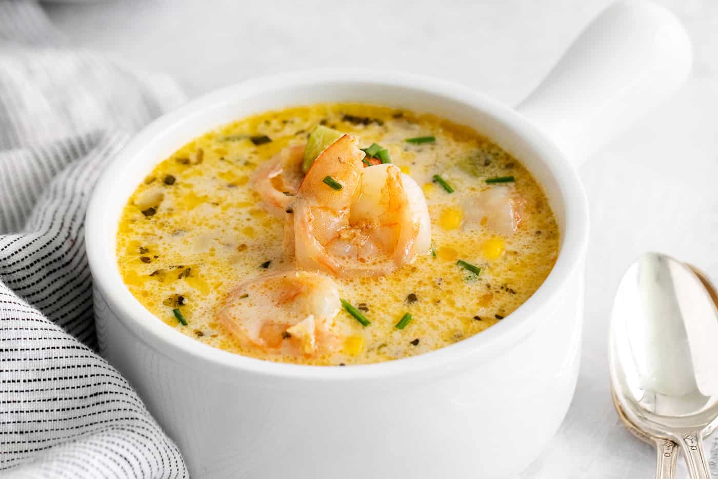 This shrimp and corn chowder has a light, creamy broth and is filled with sautéed vegetables, tender shrimp, and fresh sweet corn. A bowl of shrimp corn chowder