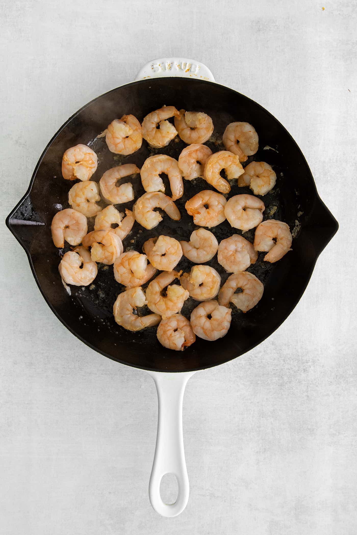 Camarones a la Diabla is a classic Mexican seafood dish that features fresh shrimp, dried chiles, and ripe tomatoes. Ready in 30 minutes! Shrimp in a cast iron skillet