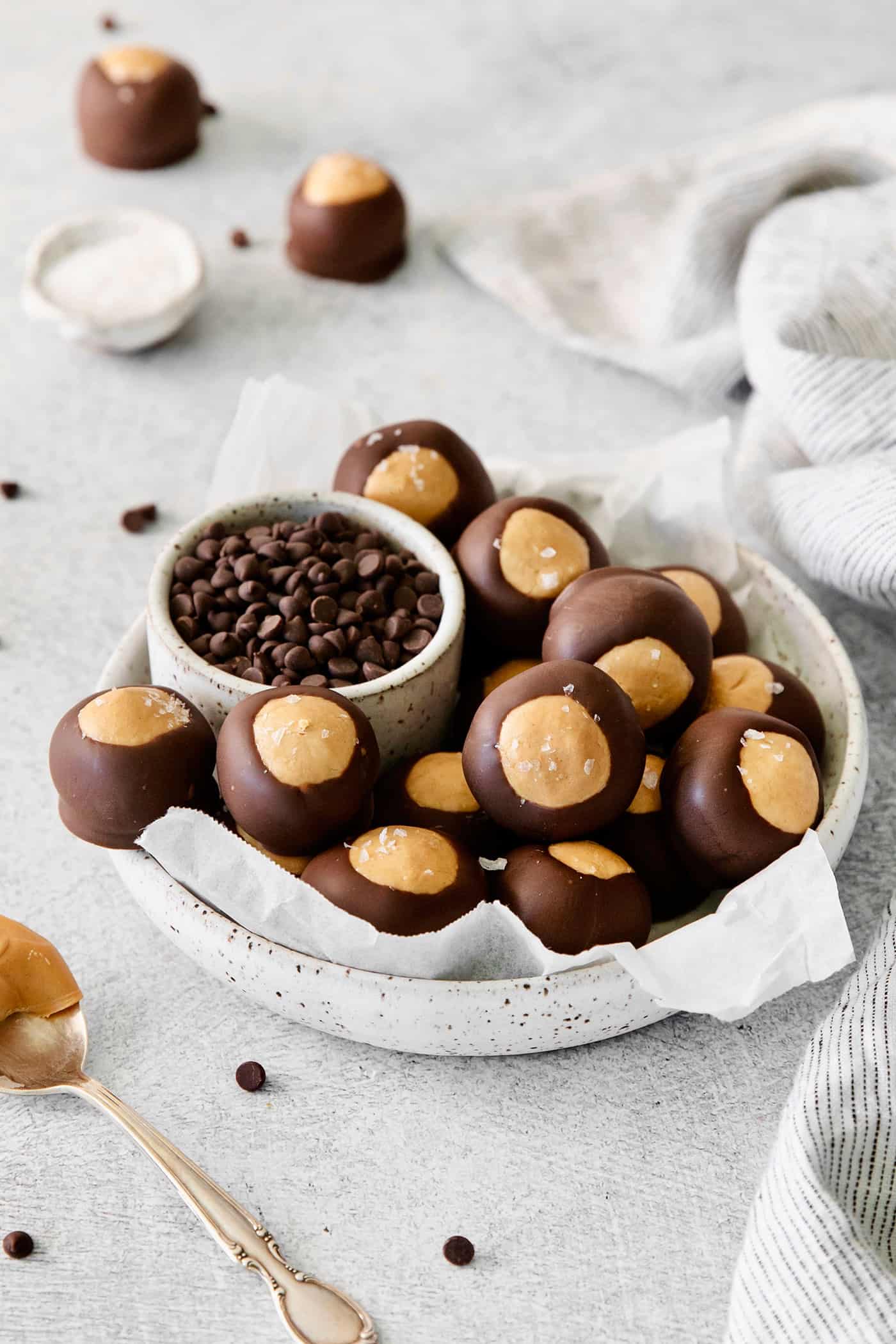 These Homemade Buckeyes feature creamy peanut butter balls dipped in rich, smooth semi-sweet chocolate. Just 7 ingredients! Overhead view of a bowl of buckeyes