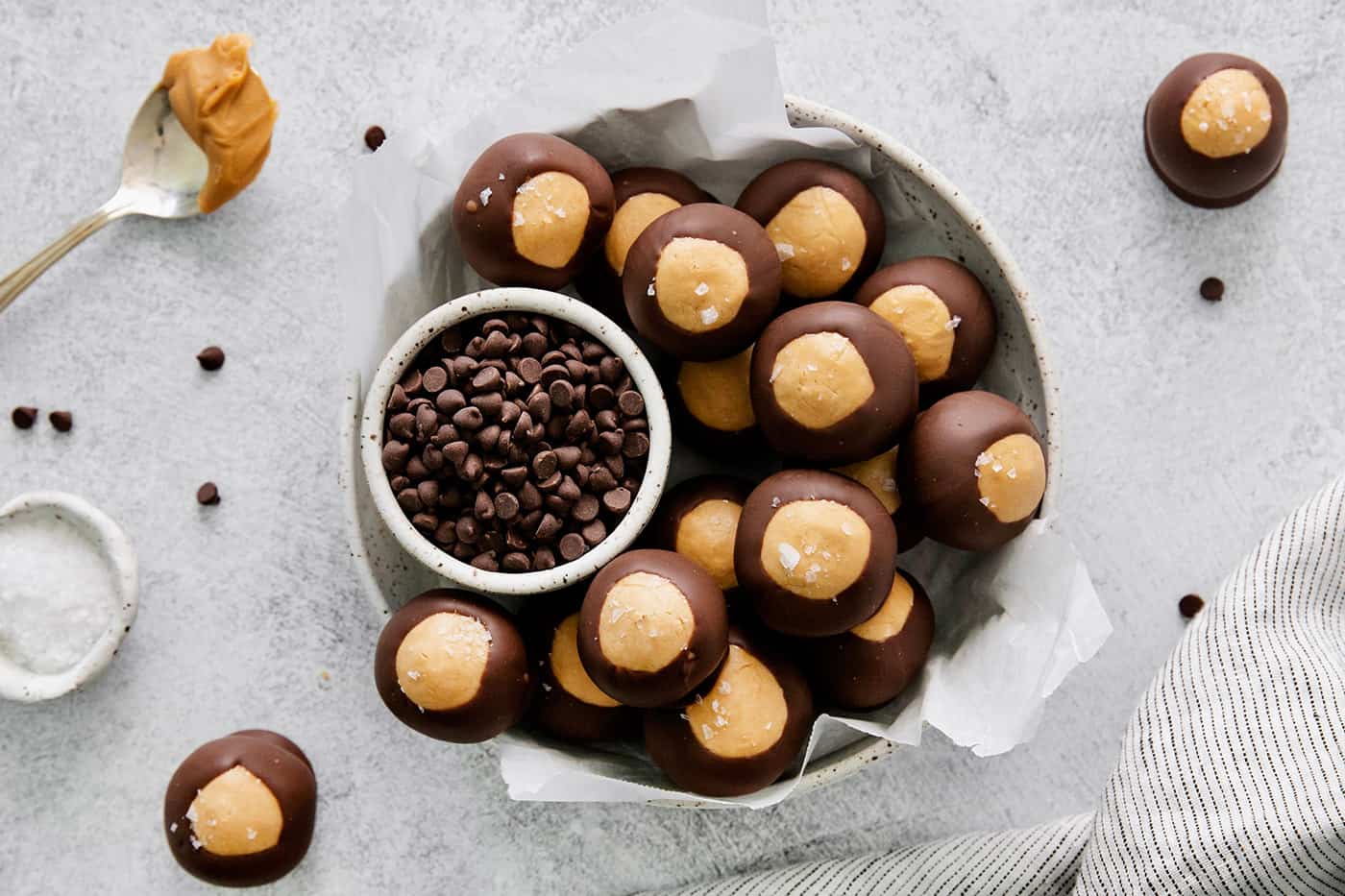 These Homemade Buckeyes feature creamy peanut butter balls dipped in rich, smooth semi-sweet chocolate. Just 7 ingredients! Overhead view of a bowl of buckeye candy