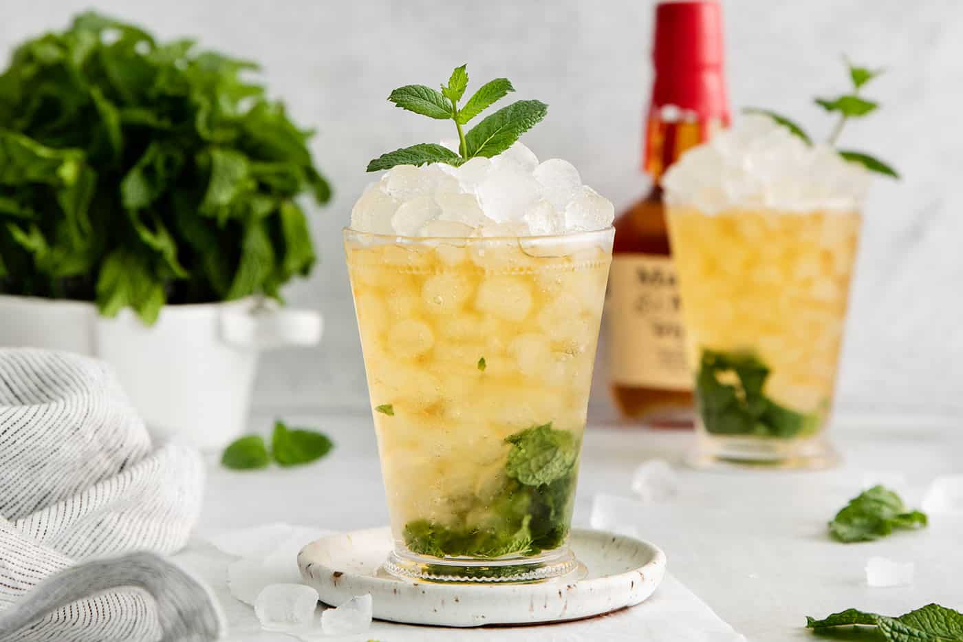 This classic Mint Julep is bright and refreshing, with fresh mint and bourbon. You only need 3 ingredients and a few minutes to make this! A mint julep cocktail in a clear glass