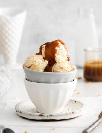 A bowl of ice cream topped with caramel sauce