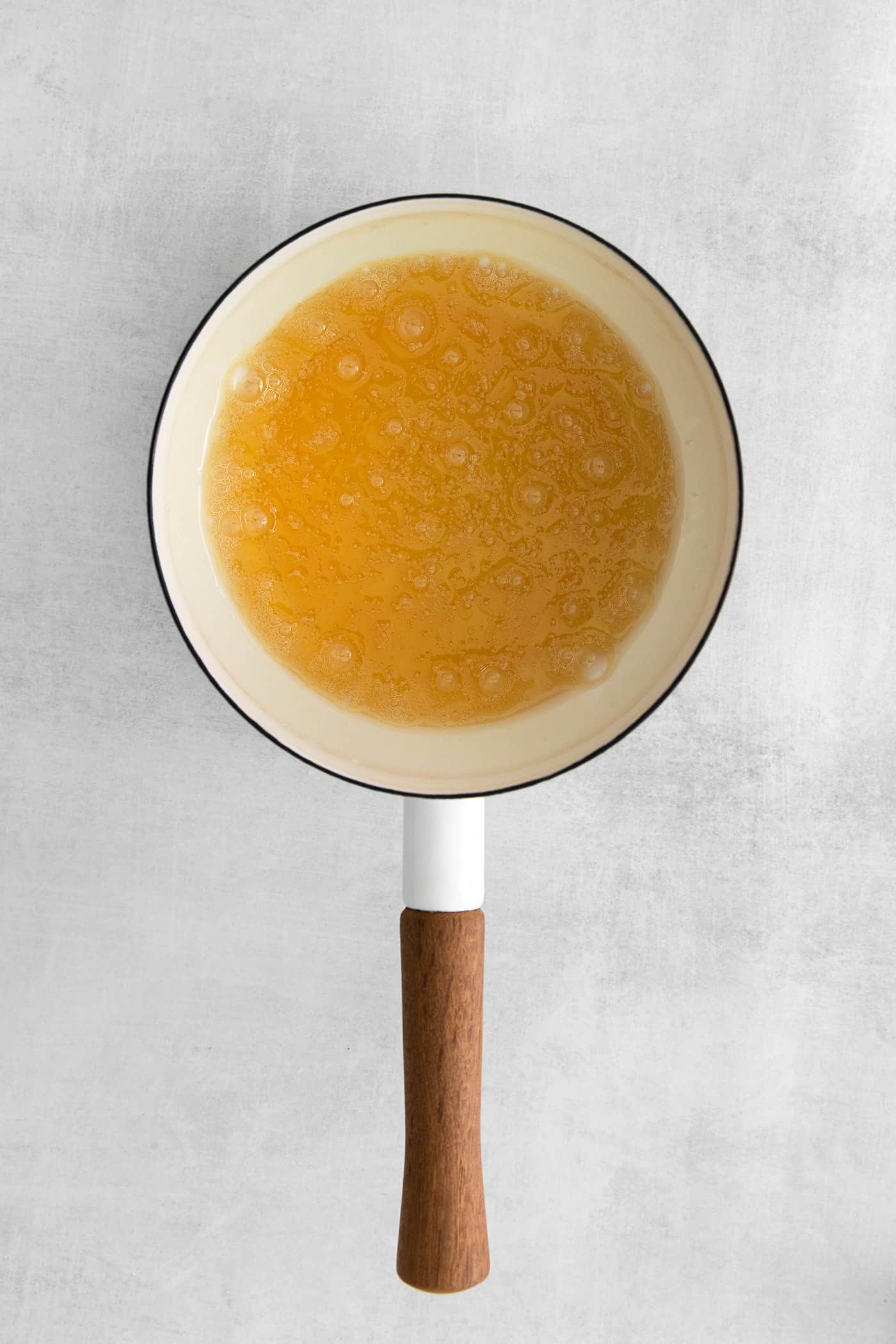This Salted Caramel Ice Cream features a sweet and creamy ice cream base with homemade caramel sauce swirled throughout. Caramel in a saucepan