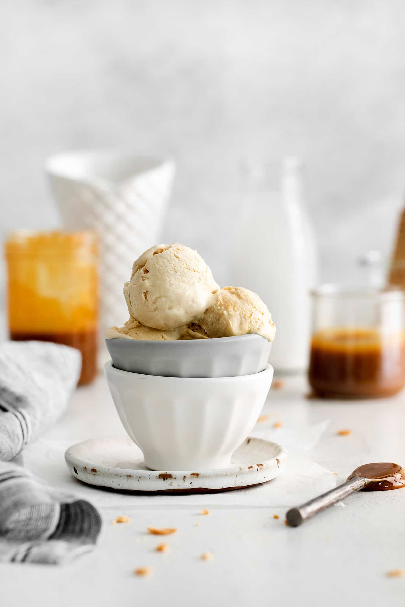 This Salted Caramel Ice Cream features a sweet and creamy ice cream base with homemade caramel sauce swirled throughout. A bowl of scoops of homemade caramel ice cream