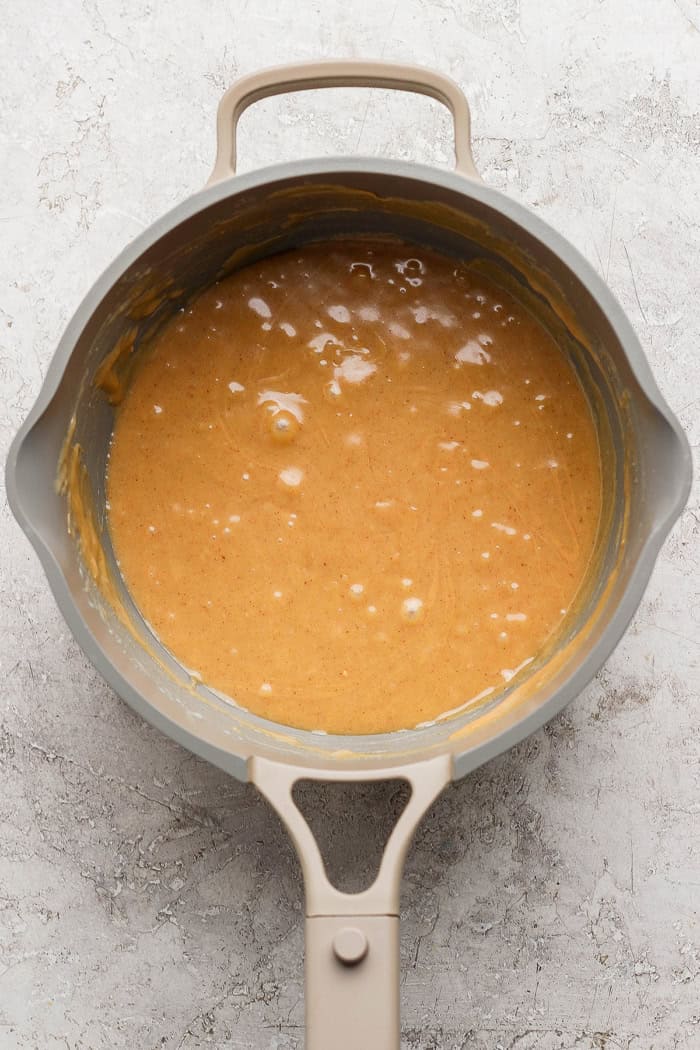 Salted Nut Roll Bars are the perfect salty and sweet combo, an easy riff on the classic candy bar. Just 5 ingredients and 15 minutes of prep! Peanut butter and condensed milk mixture in saucepan.