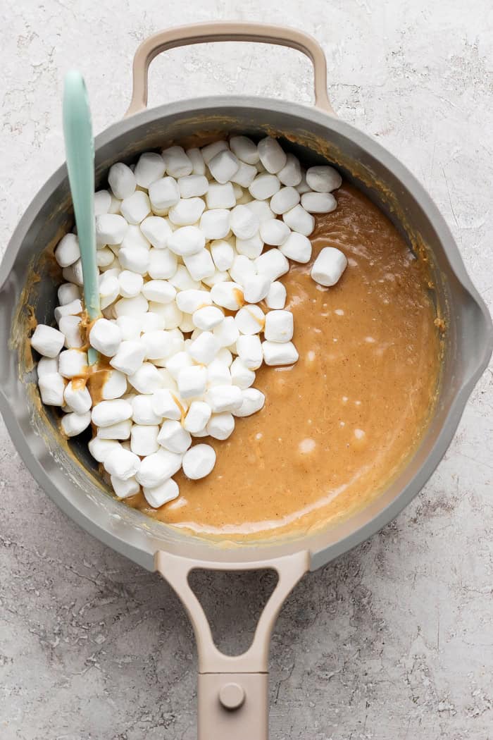 Salted Nut Roll Bars are the perfect salty and sweet combo, an easy riff on the classic candy bar. Just 5 ingredients and 15 minutes of prep! Marshmallows added to condensed milk and peanut butter mixture in pan.