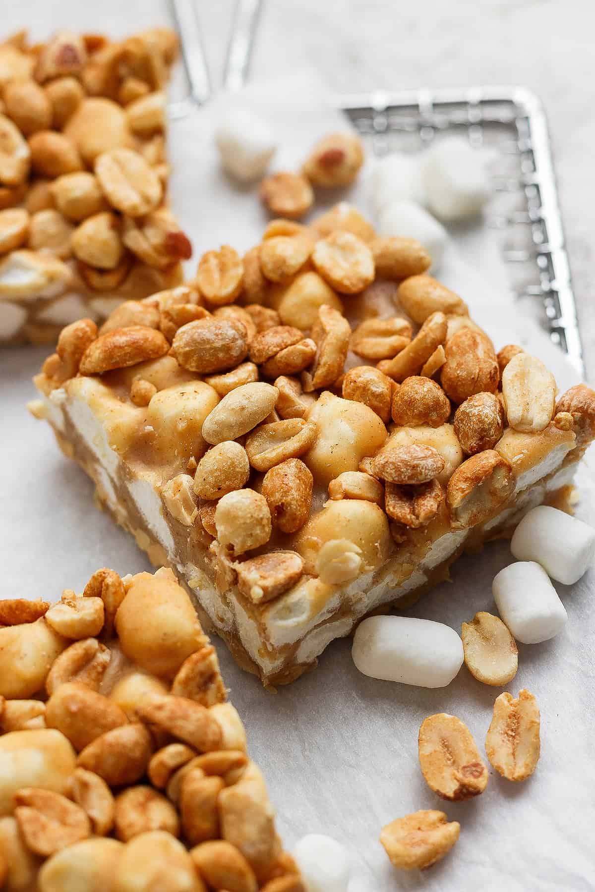 Salted Nut Roll Bars are the perfect salty and sweet combo, an easy riff on the classic candy bar. Just 5 ingredients and 15 minutes of prep! 3 salted nut roll bars with peanuts and marshmallows.