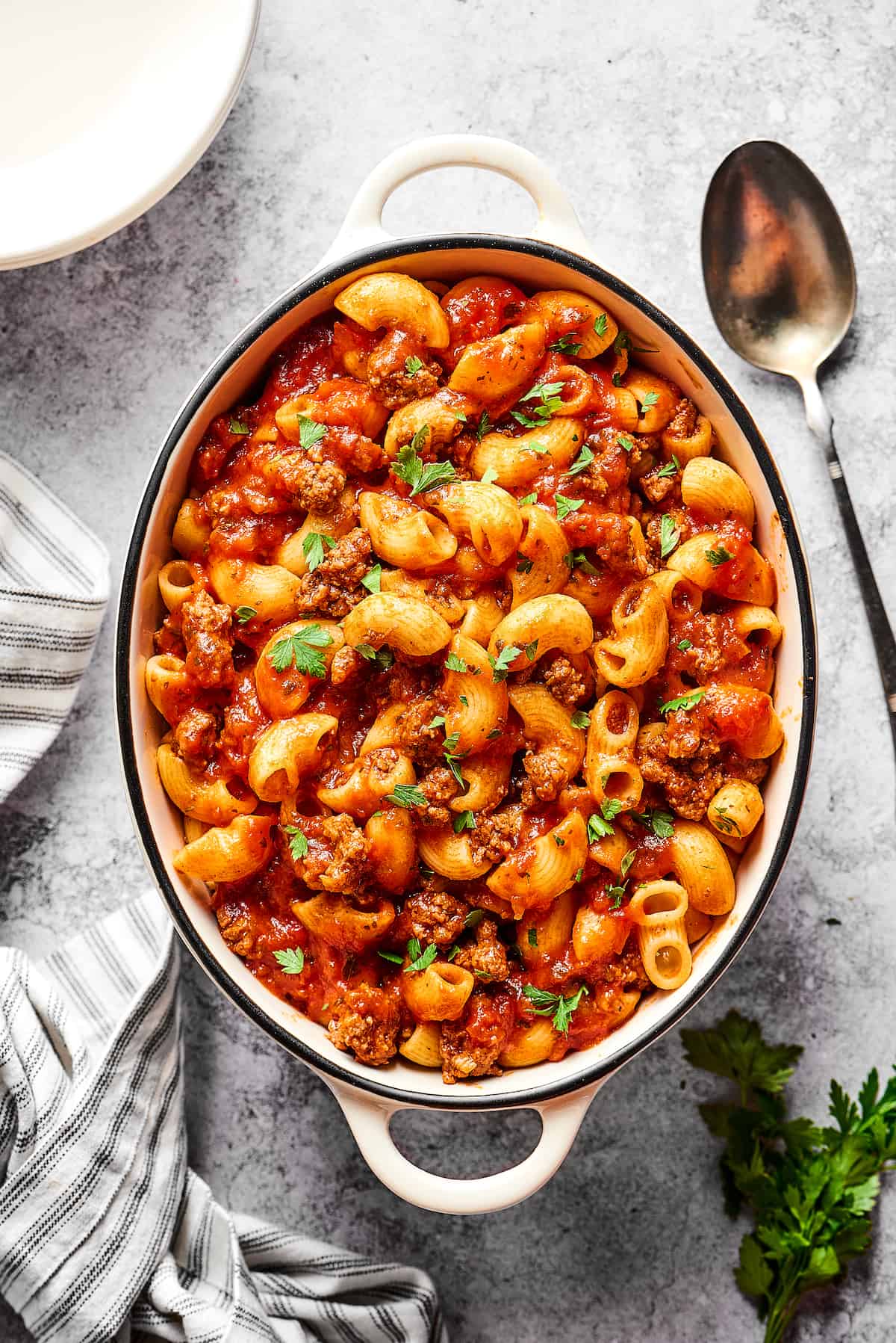 Made with tomato sauce, ground beef, and elbow macaroni, this Easy Beefaroni is the homemade version of the canned classic. Quick & easy! Overhead view of a dish of American goulash