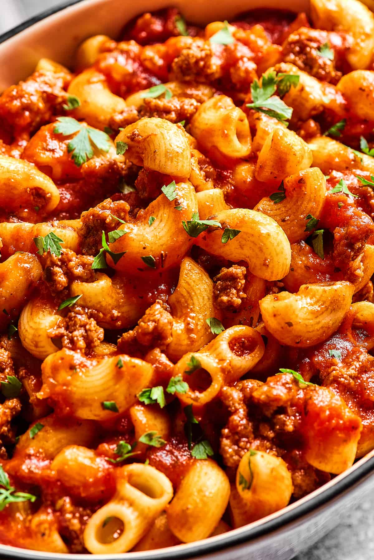 Made with tomato sauce, ground beef, and elbow macaroni, this Easy Beefaroni is the homemade version of the canned classic. Quick & easy! Overhead view of homemade beefaroni in a baking dish