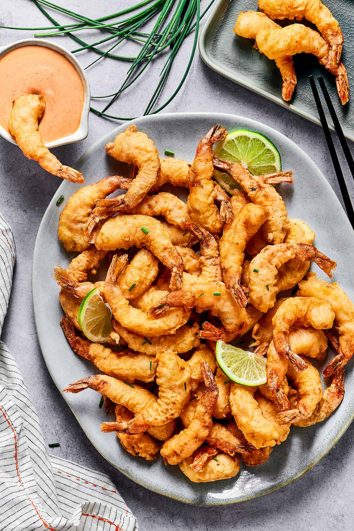 This easy shrimp tempura recipe features juicy, tender shrimp dipped in a light tempura batter. It's then deep-fried until perfectly crispy! Overhead view of a plate of shrimp tempura