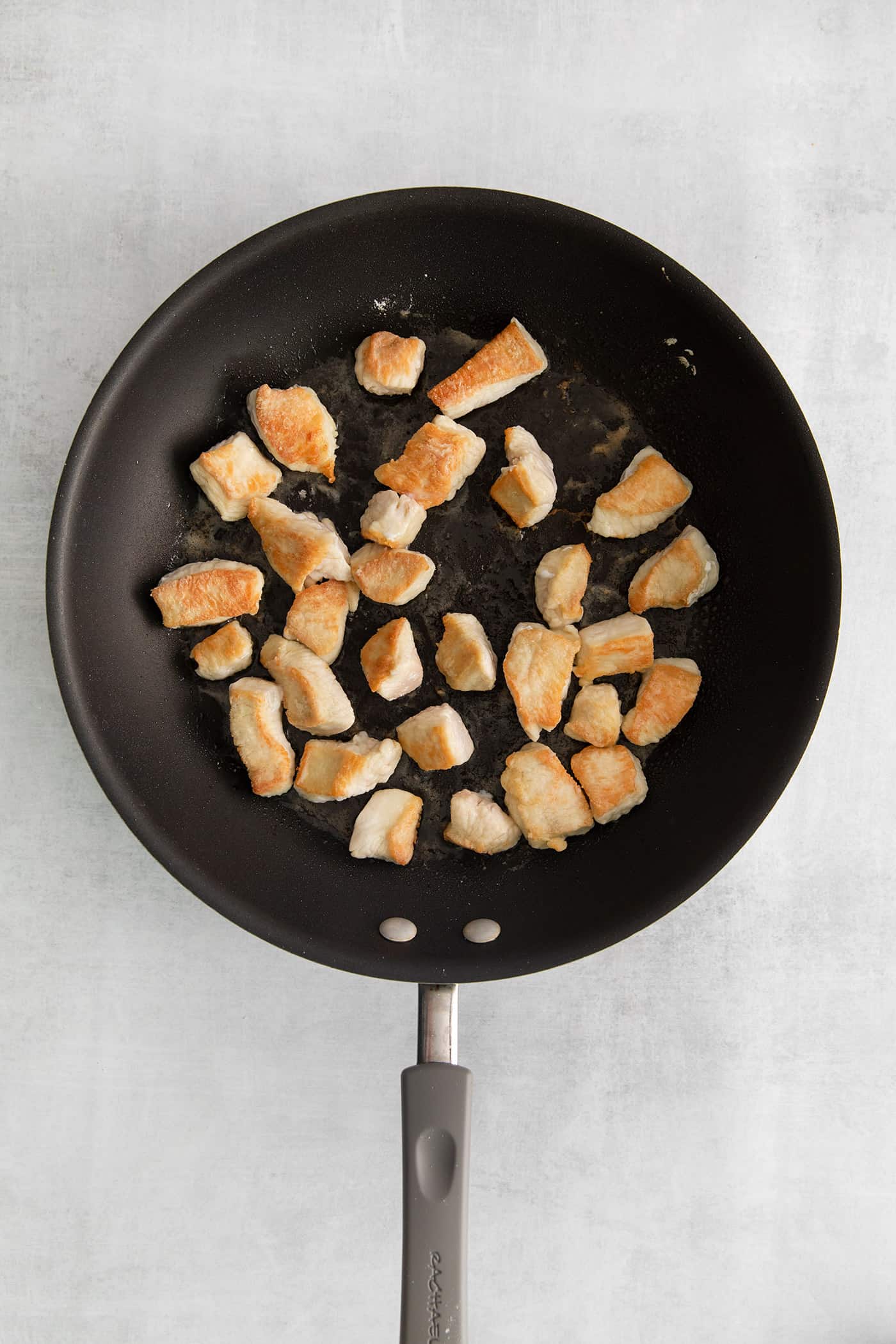 Made with glass noodles, mixed vegetables, and a savory soy glaze, Pad Woon Sen is an easy Thai stir fry that's ready in just 30 minutes! Pieces of seared chicken in a skillet