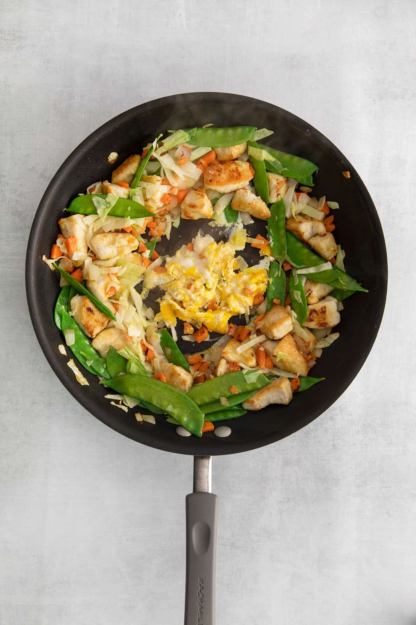 Made with glass noodles, mixed vegetables, and a savory soy glaze, Pad Woon Sen is an easy Thai stir fry that's ready in just 30 minutes! Chicken stir fry with egg in the center