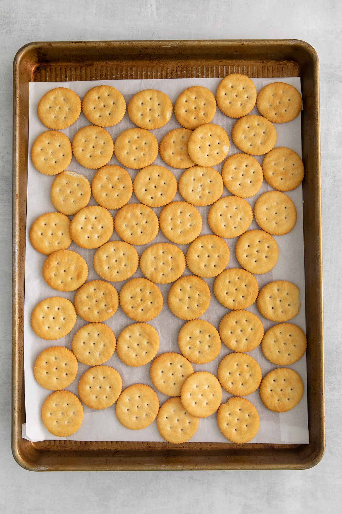 Ritz crackers on a baking sheet