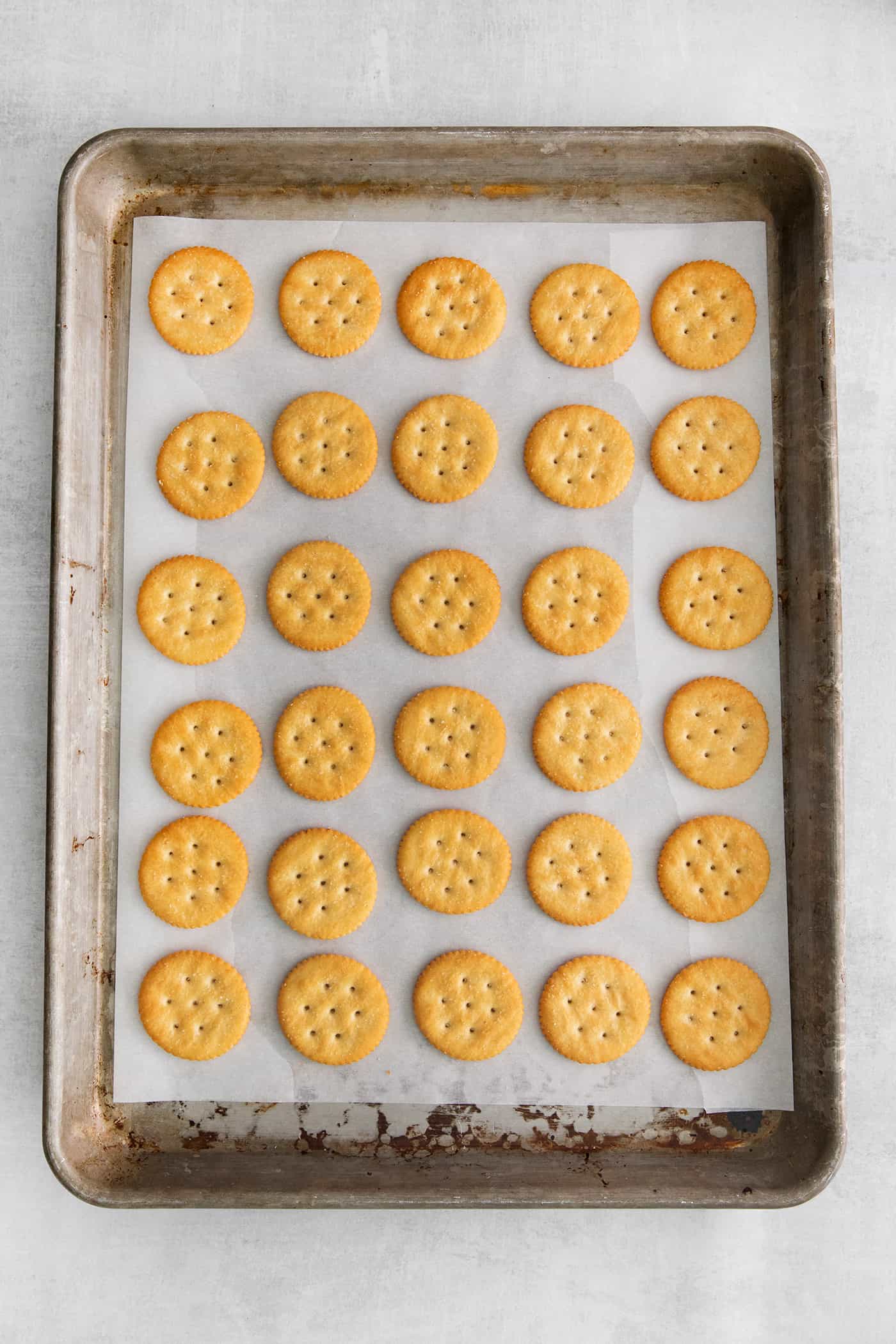 Made with 6 ingredients, Ritz Turtles are a fun, easy treat. These Ritz cracker caramel cookies are sweet, salty, crunchy & chewy all in one. Ritz crackers on a baking sheet