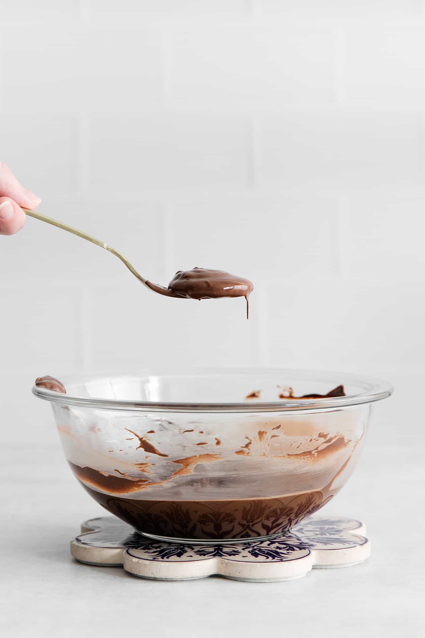 Made with 6 ingredients, Ritz Turtles are a fun, easy treat. These Ritz cracker caramel cookies are sweet, salty, crunchy & chewy all in one. A spoon holding a chocolate dipped ritz cracker over a bowl of chocolate