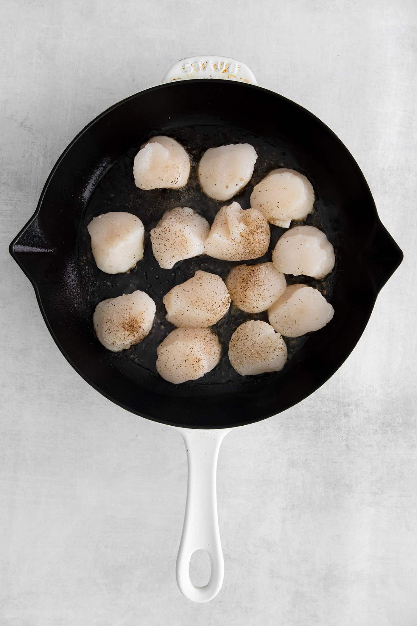 Made with a simple lemon garlic butter sauce, these Pan Seared Scallops are guaranteed to be the highlight of any dinner. Sea scallops cooking in a skillet