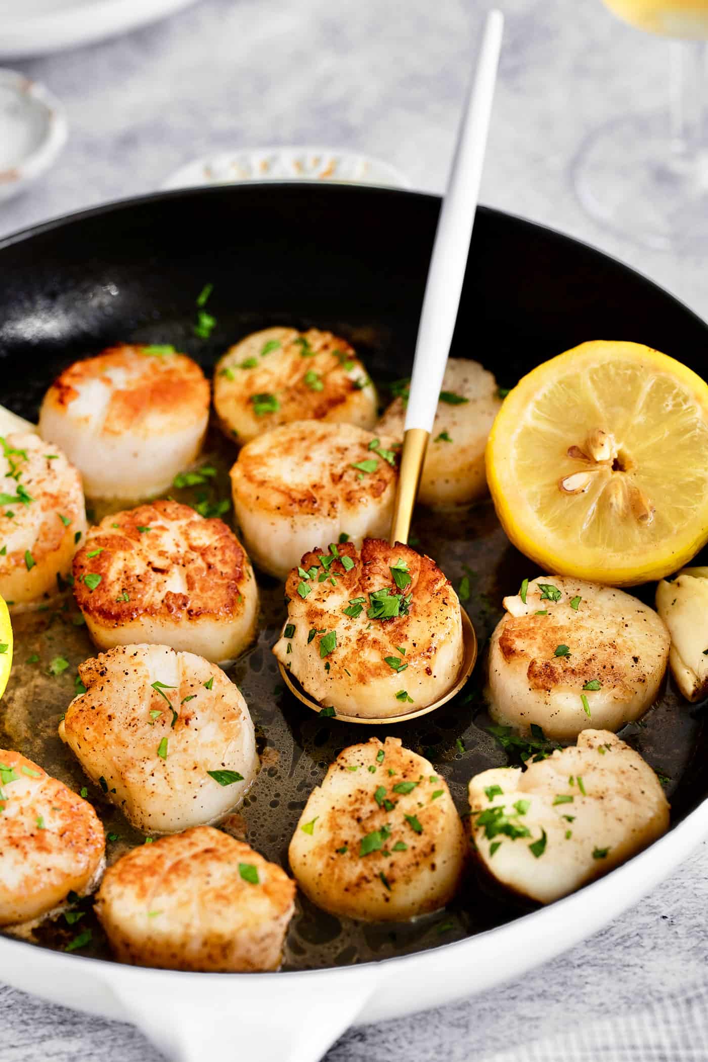 Made with a simple lemon garlic butter sauce, these Pan Seared Scallops are guaranteed to be the highlight of any dinner. Lemon garlic scallops in a skillet
