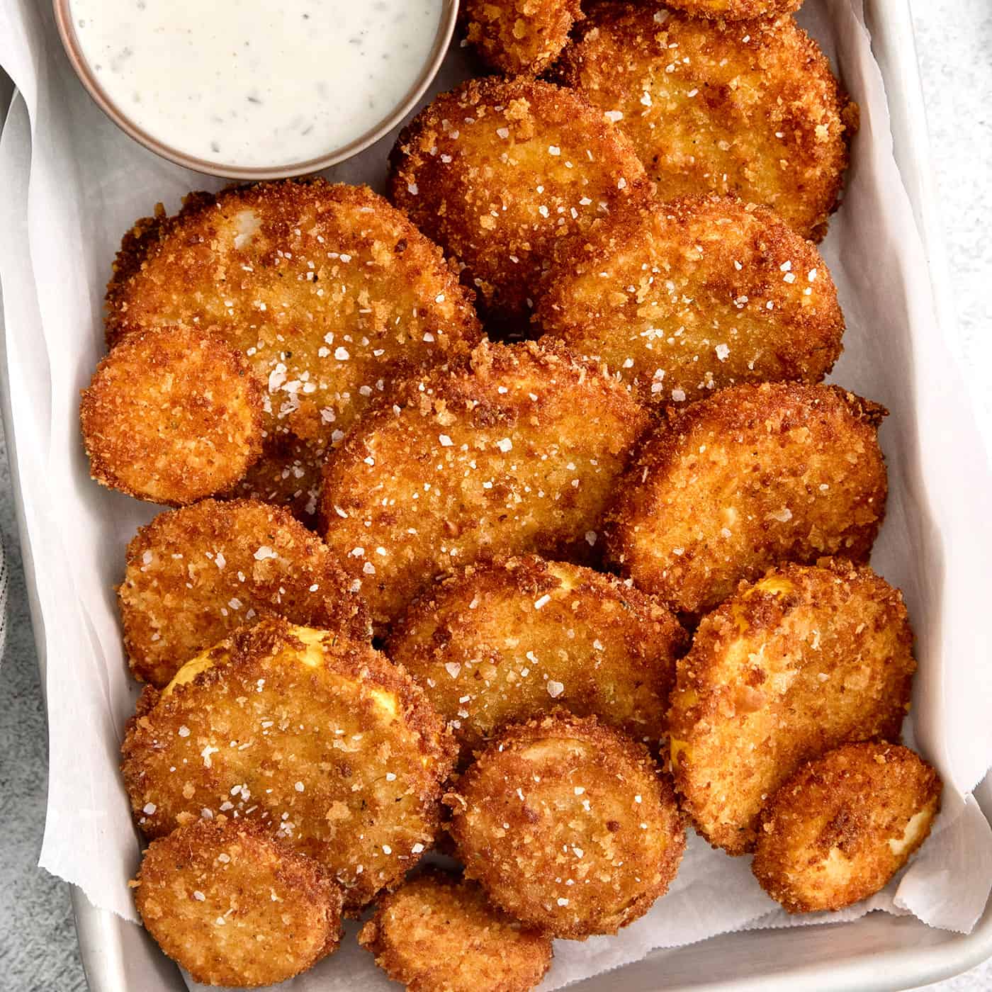This easy, flavorful fried yellow squash is delightfully crispy on the outside and tender on the inside. Grab your favorite dip and enjoy! Overhead view of fried squash