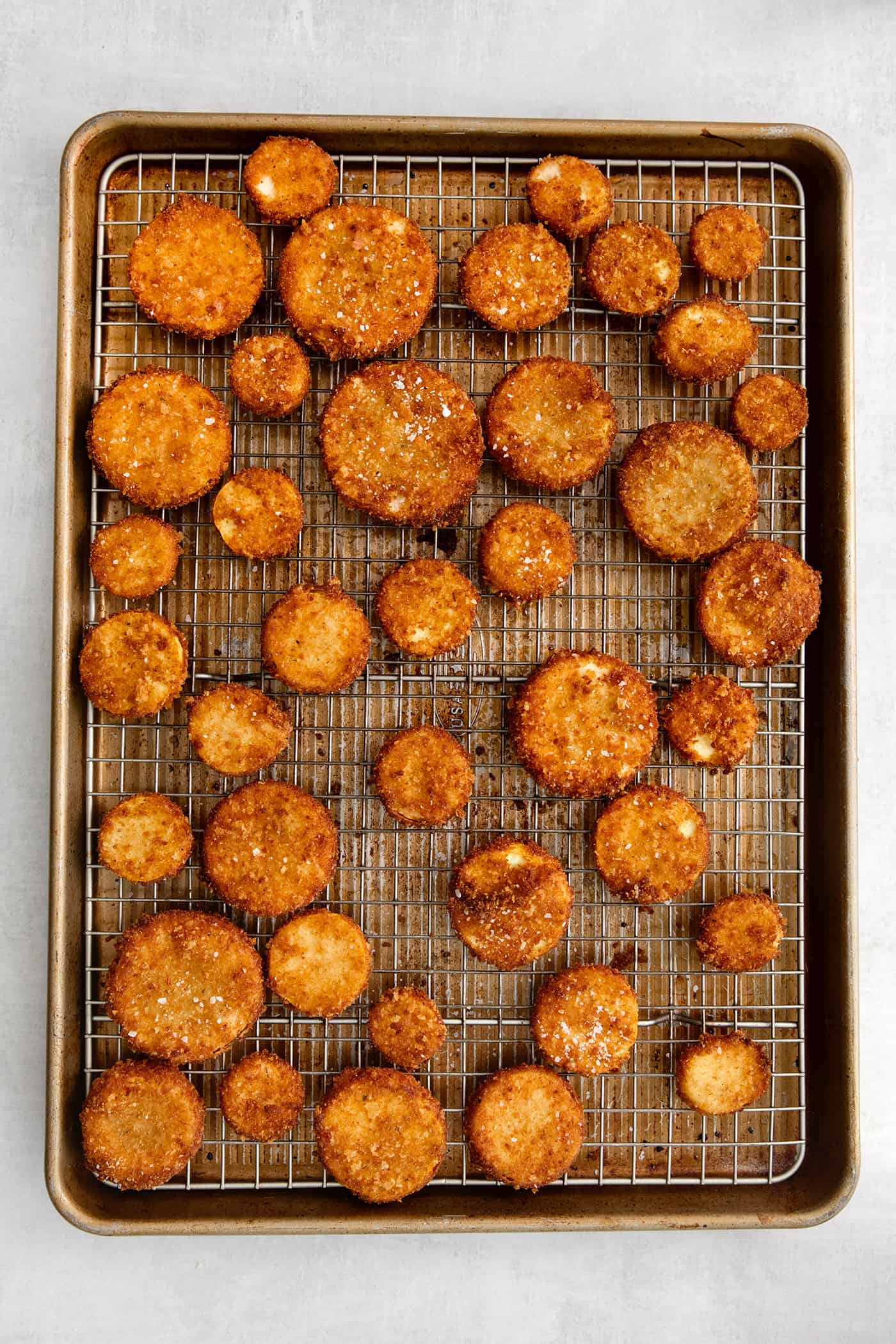 This easy, flavorful fried yellow squash is delightfully crispy on the outside and tender on the inside. Grab your favorite dip and enjoy! Overhead view of fried squash on a wire rack
