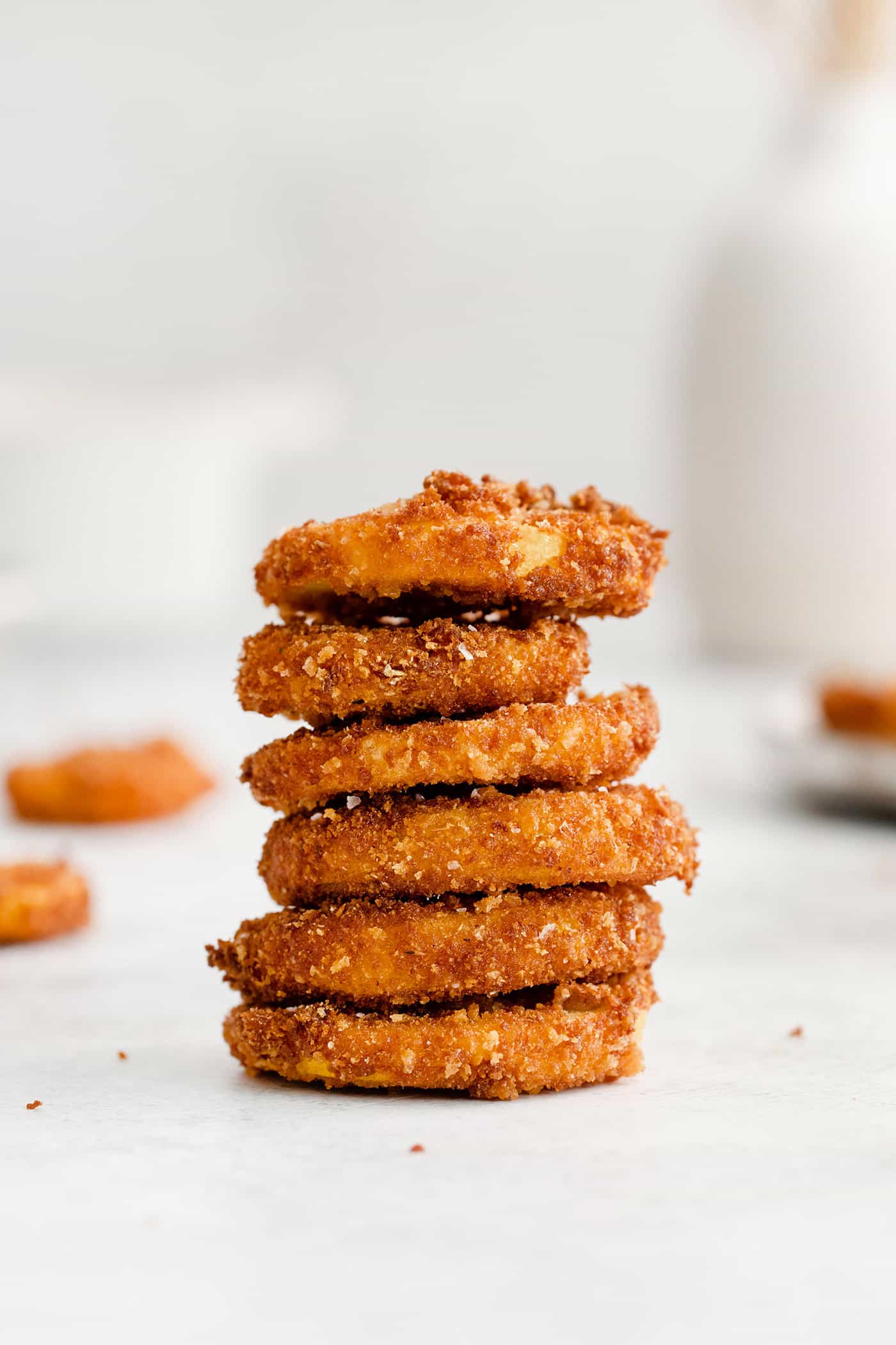 This easy, flavorful fried yellow squash is delightfully crispy on the outside and tender on the inside. Grab your favorite dip and enjoy! A pile of fried yellow squash rounds