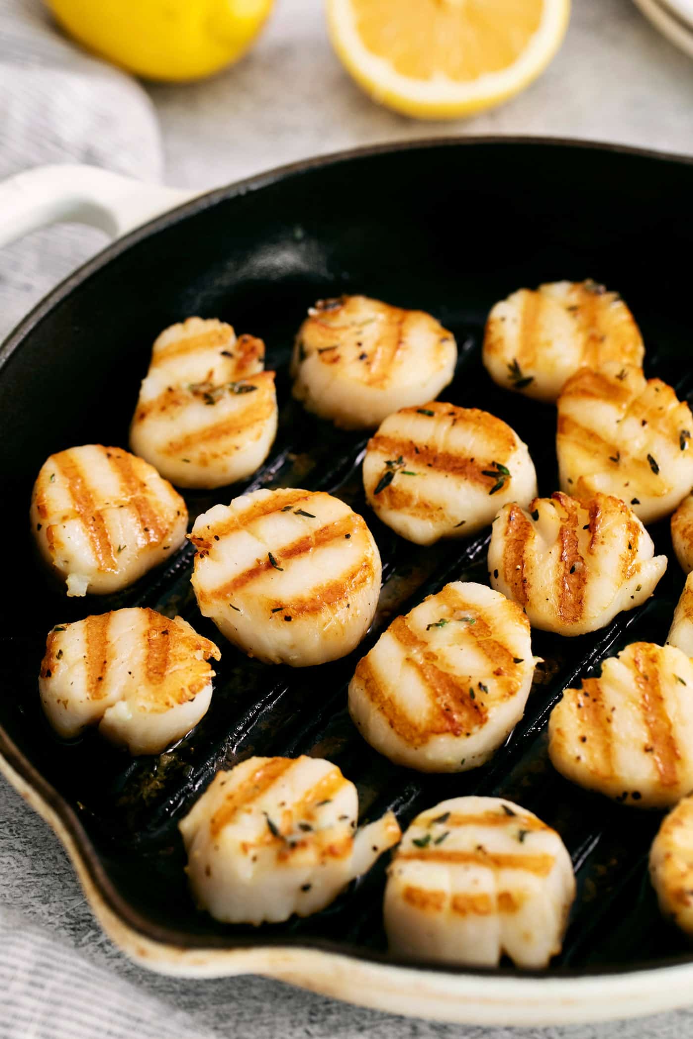 These easy grilled sea scallops are done in 20 minutes and richly flavored with garlic butter and lemon. Cook on an indoor or outdoor grill! Grilled scallops in a grill pan