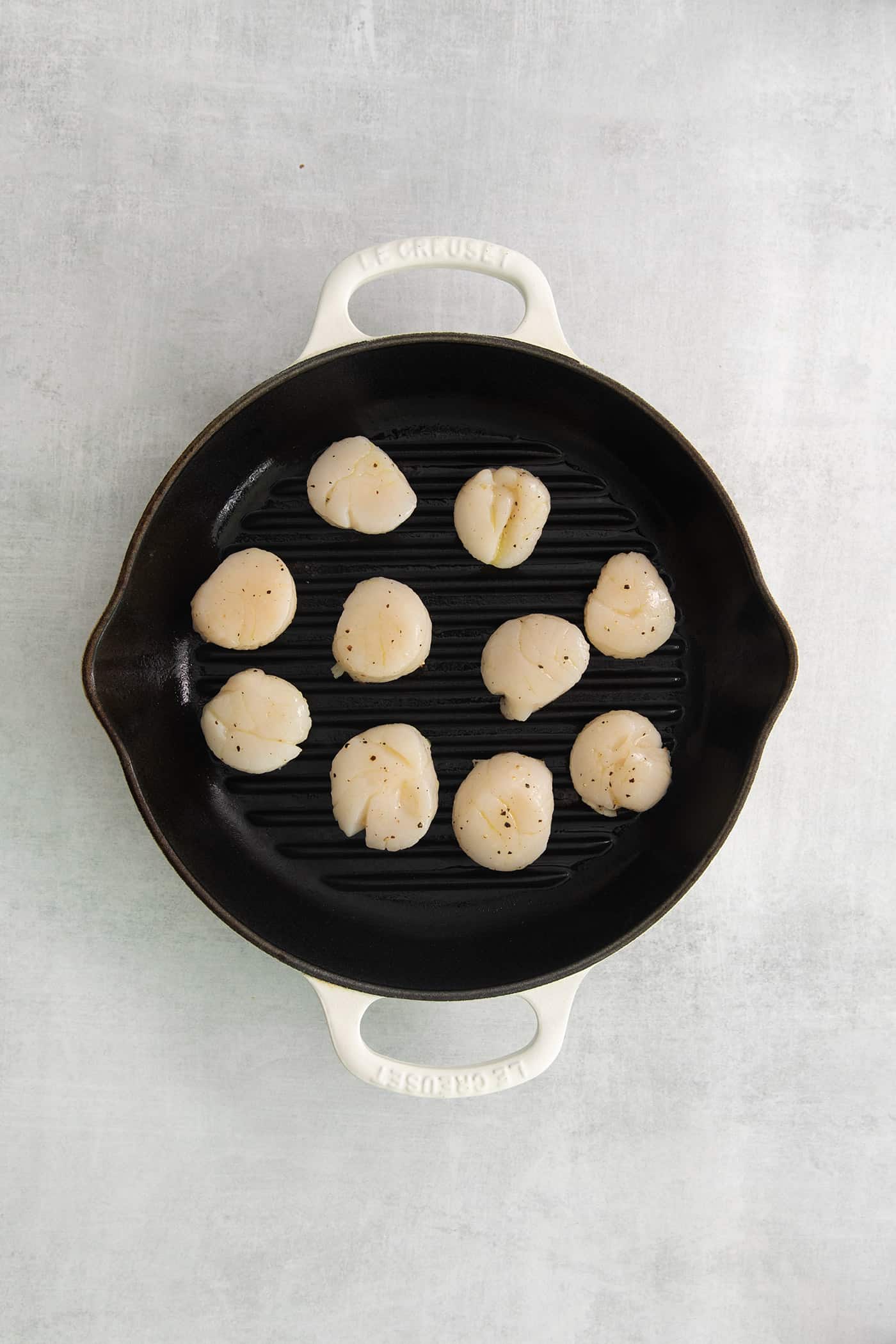 These easy grilled sea scallops are done in 20 minutes and richly flavored with garlic butter and lemon. Cook on an indoor or outdoor grill! Scallops in a grill pan