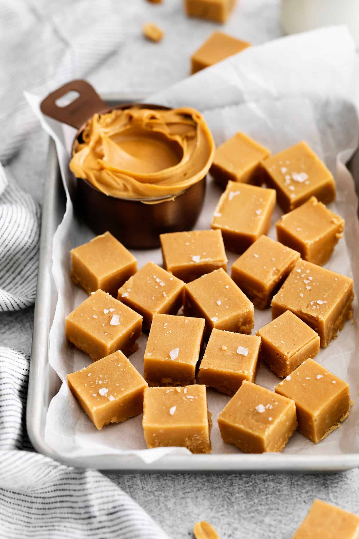 Made with 7 ingredients, this Homemade Peanut Butter Fudge is rich, creamy, and easy to make. It's the perfect fudge for the holidays! Overhead view of pieces of homemade fudge